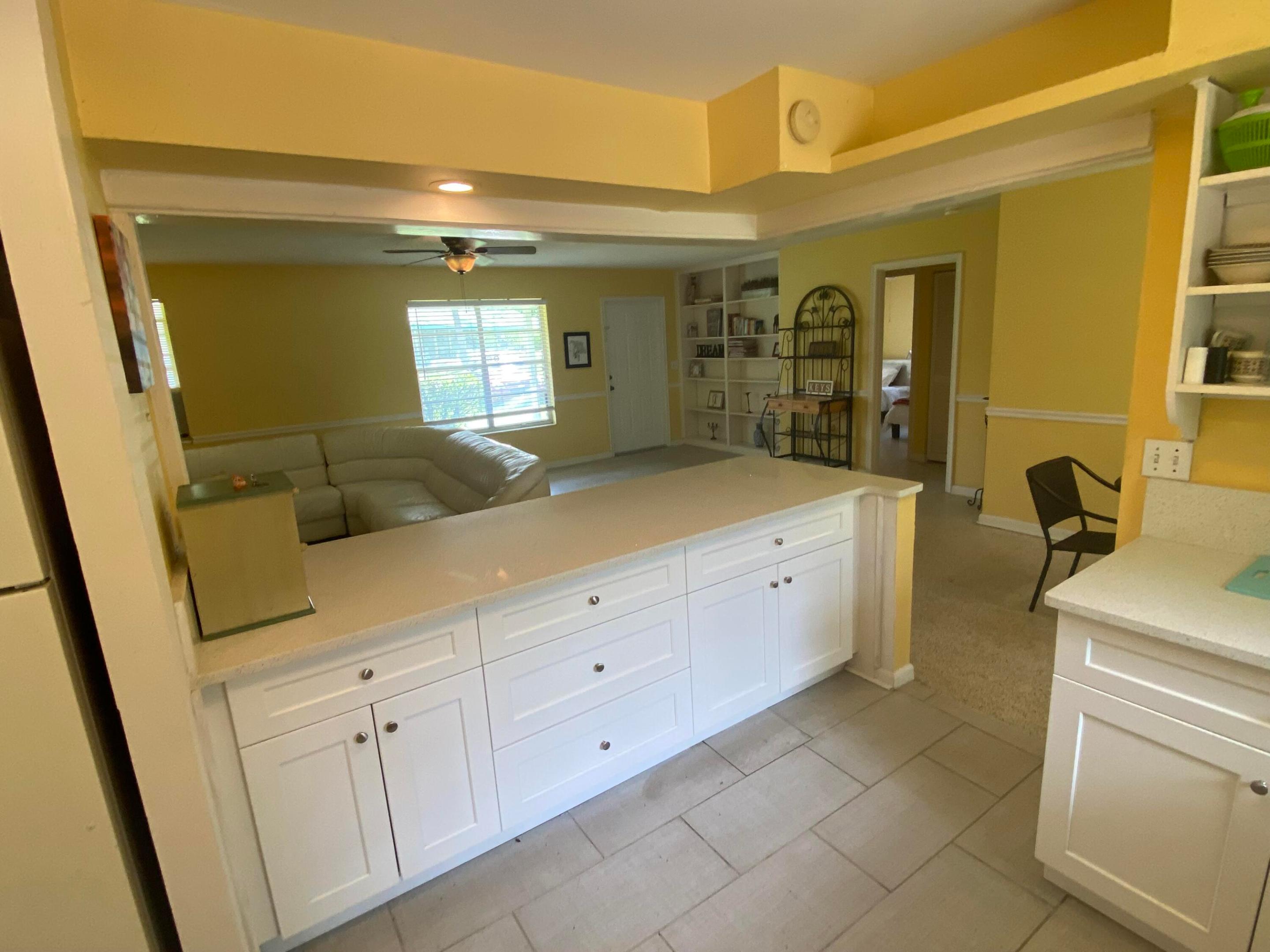 Kitchen with Refrigerator and Door to Laundry & Utility Storage Room