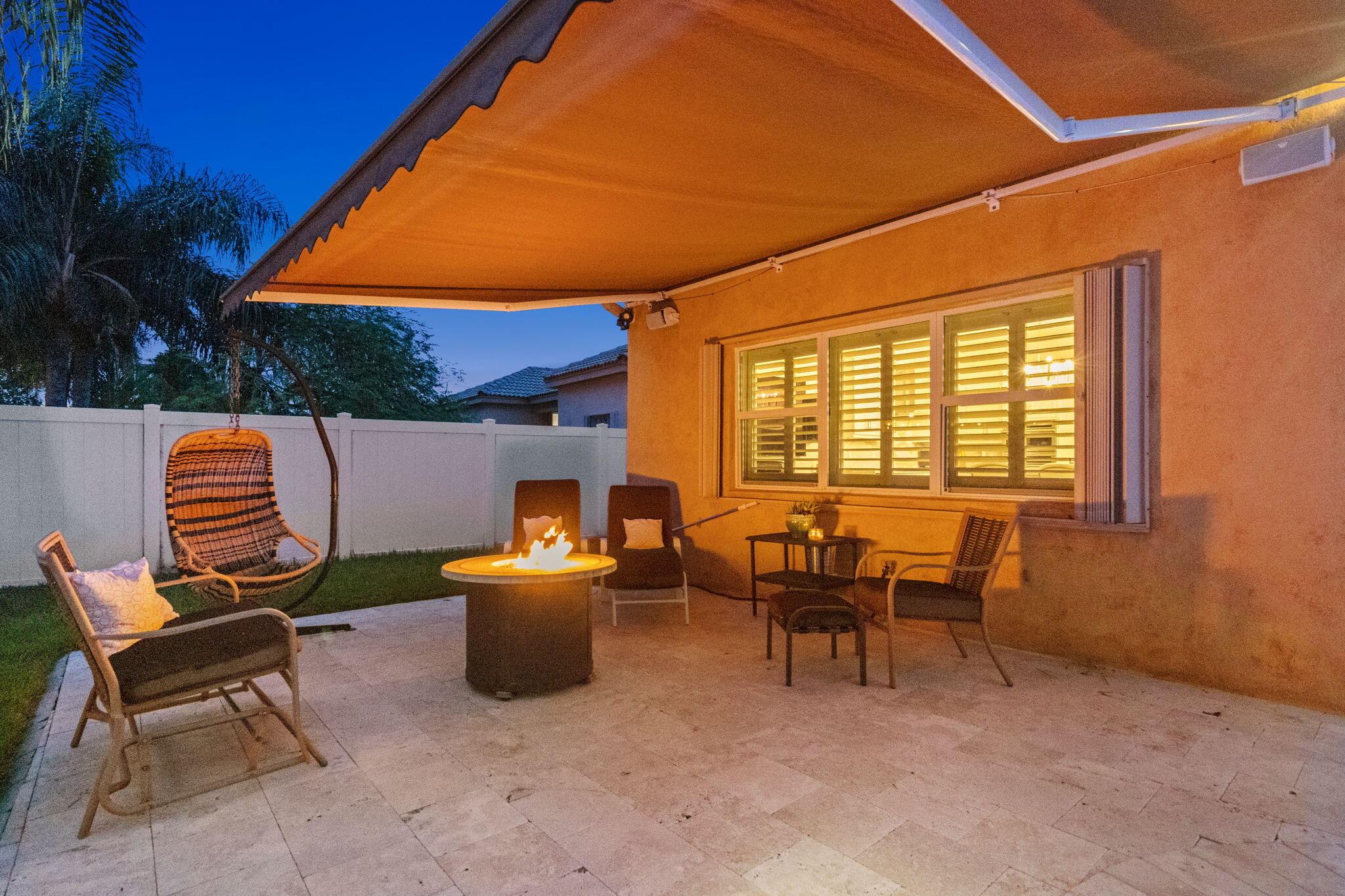 Another outdoor area with retractable awning and fire pit.