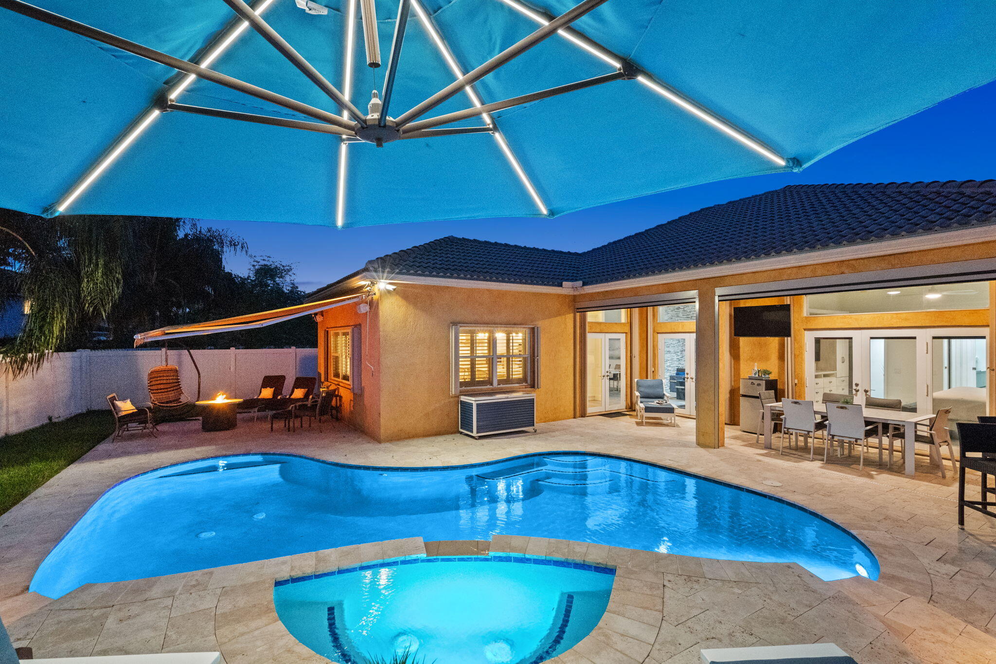 Lighted umbrella stays, overlooks the heated pool and raised spa deck.