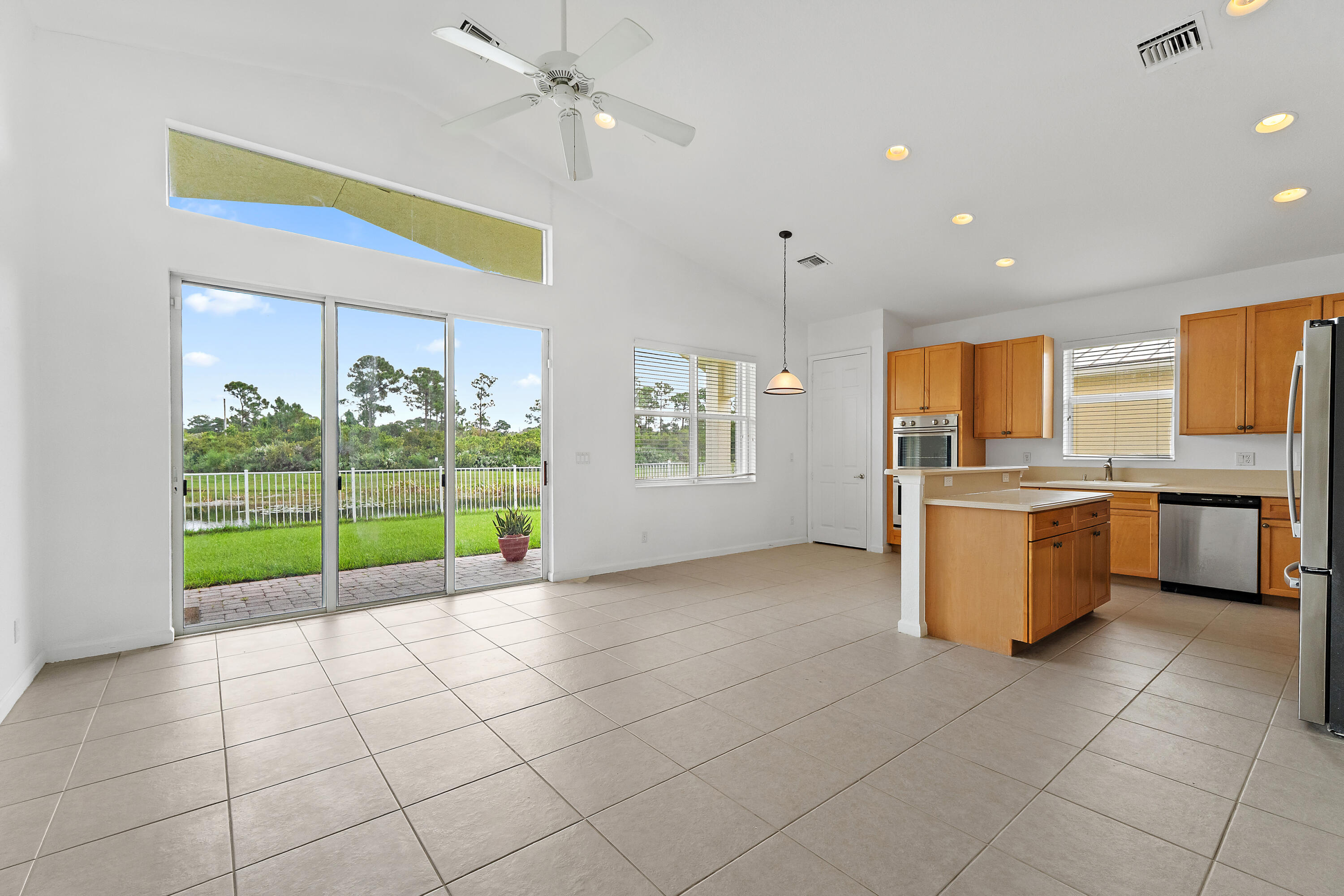 The view starts the moment you walk in. Tall sliders and the clerestory window frame the pond and preserve from the great room and kitchen.