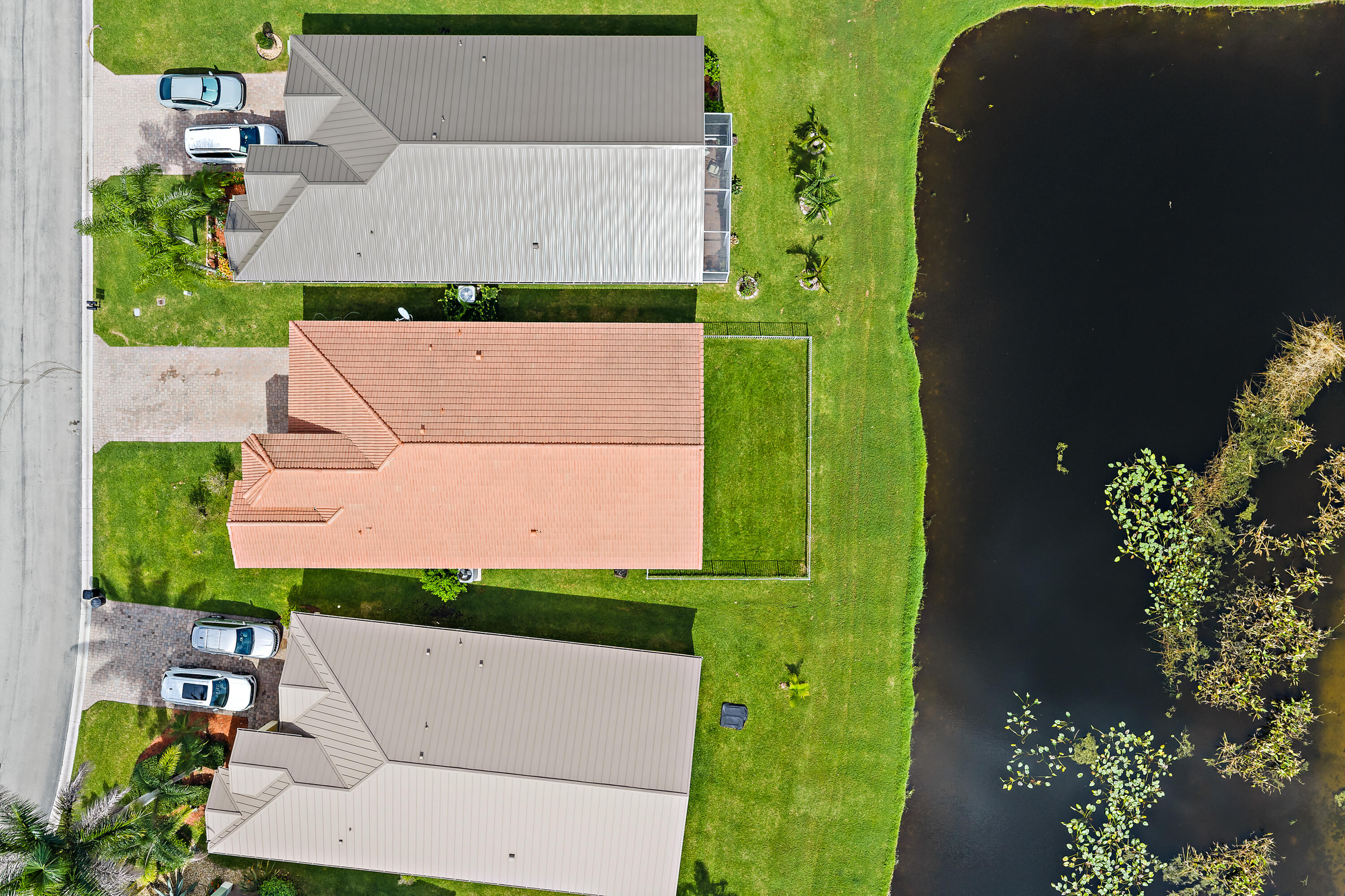 This aerial view shows what makes this home special: a peaceful pond right behind it, framed by lush trees and preserve. The home sits on a well-kept street in Martins Crossing, with water and nature views from the back of the house. Its a quiet, private setting youll love coming home to.