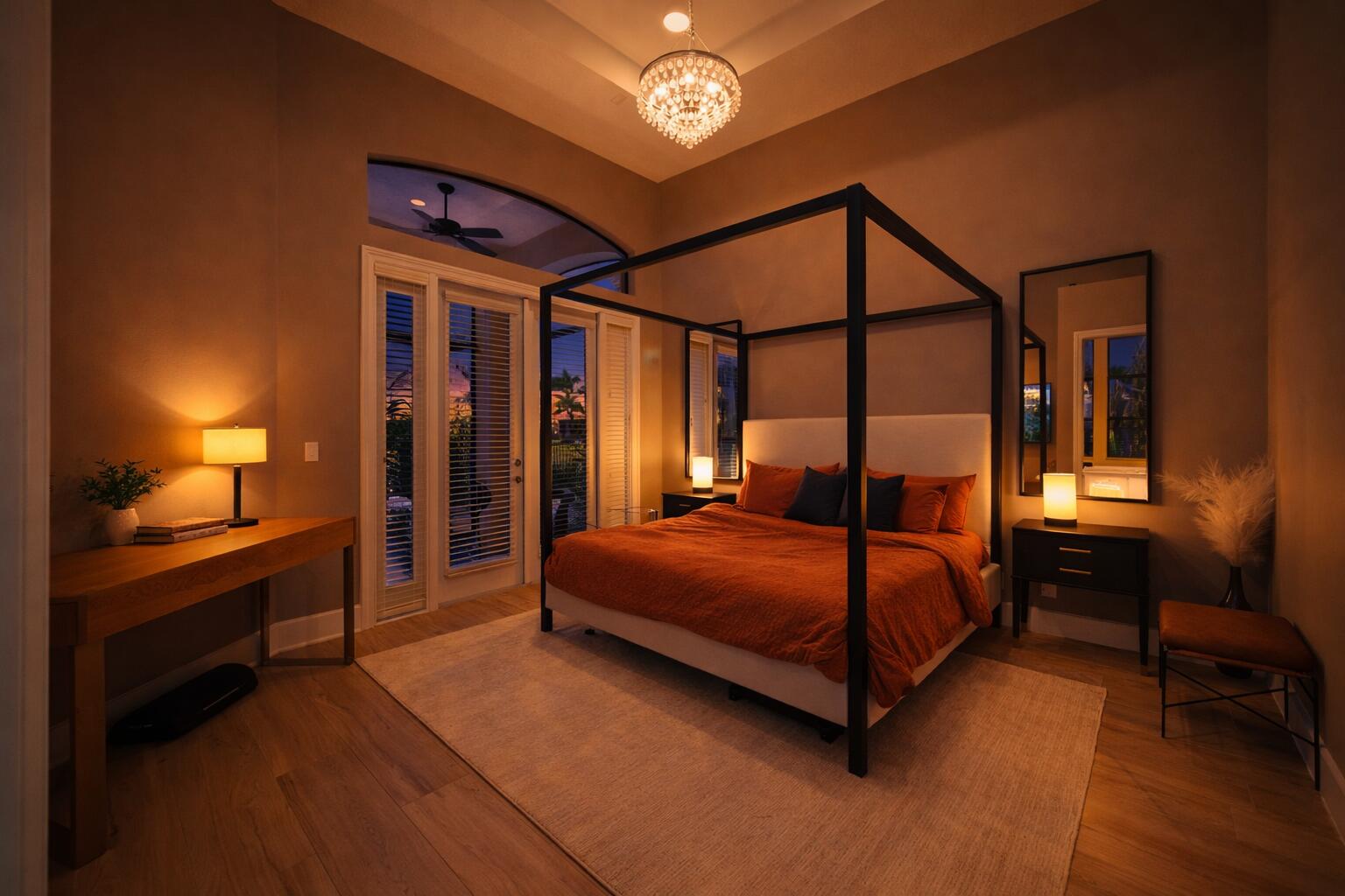 High ceilings with crown molding, crystal chandelier, arched transom window, wood-finish flooring, and glass-paneled exterior door