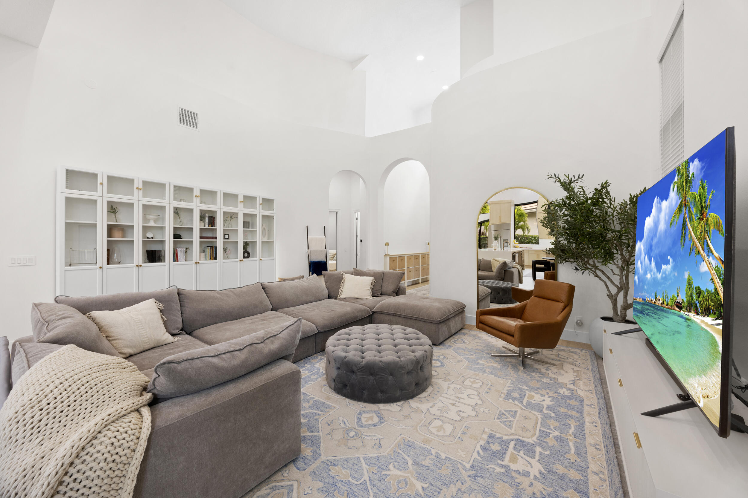 High ceilings, floor-to-ceiling built-in cabinetry, and distinctive arched architectural details