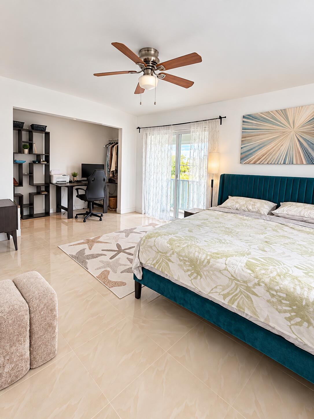 Polished tile flooring, ceiling fan with integrated lighting, and sliding glass doors with direct exterior access