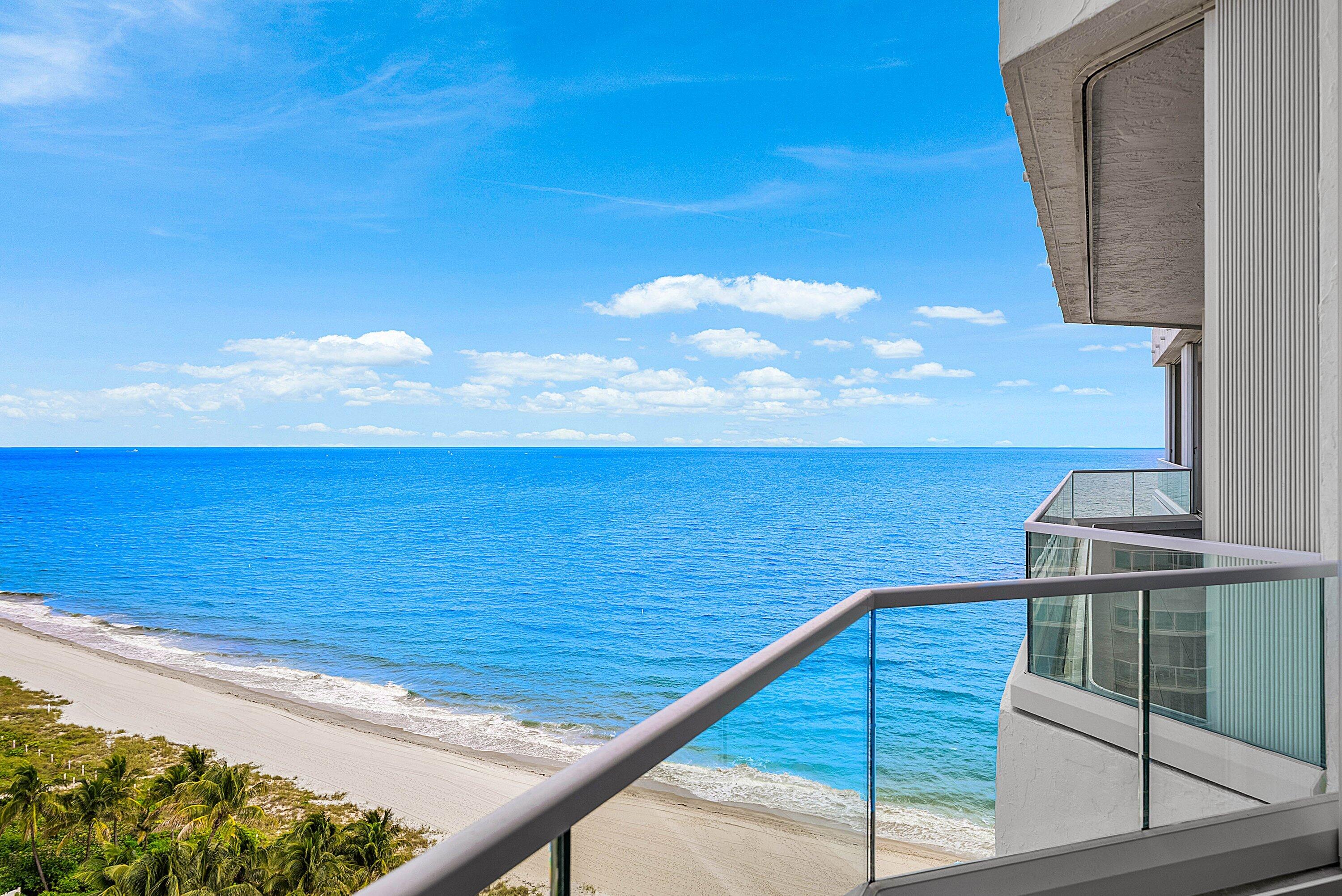 Private balcony featuring glass railings and direct oceanfront positioning