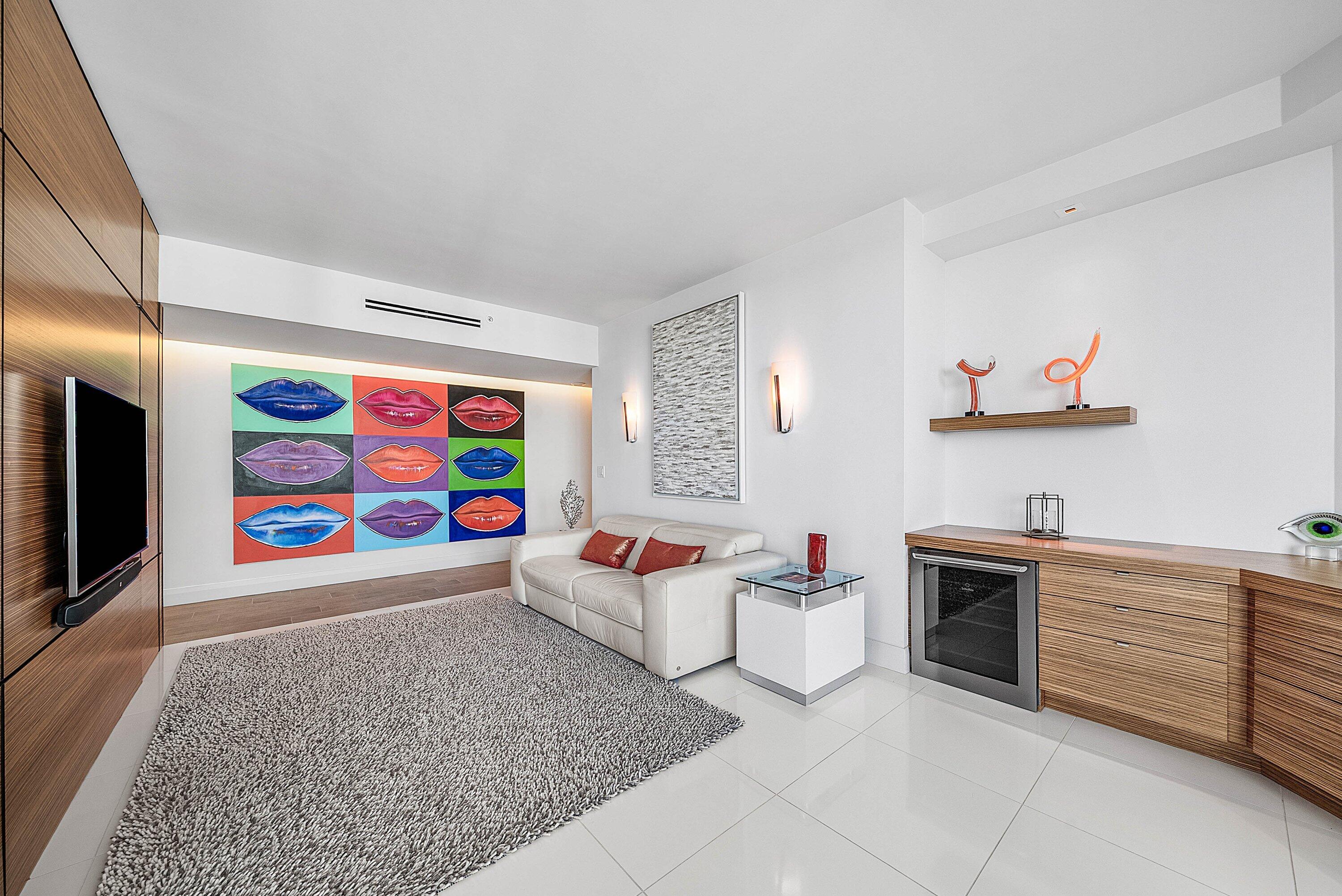 Wood-finish wall paneling, built-in cabinetry with integrated wine cooler, floating display shelf, and polished tile flooring