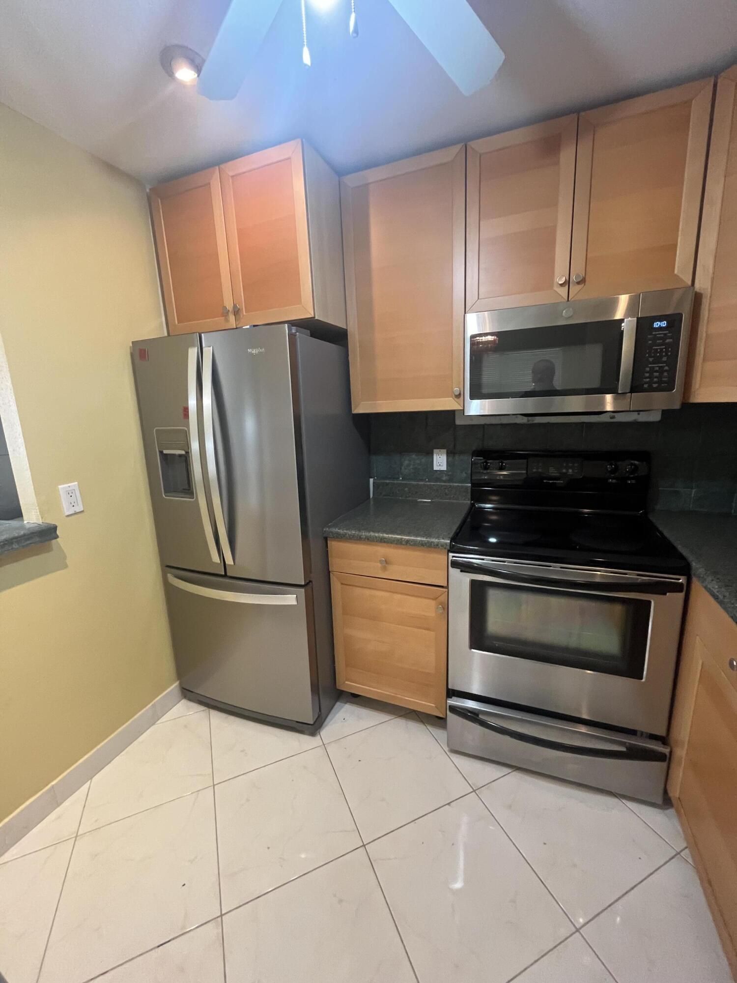 updated kitchen with stainless steel appliances and wood cabinetry