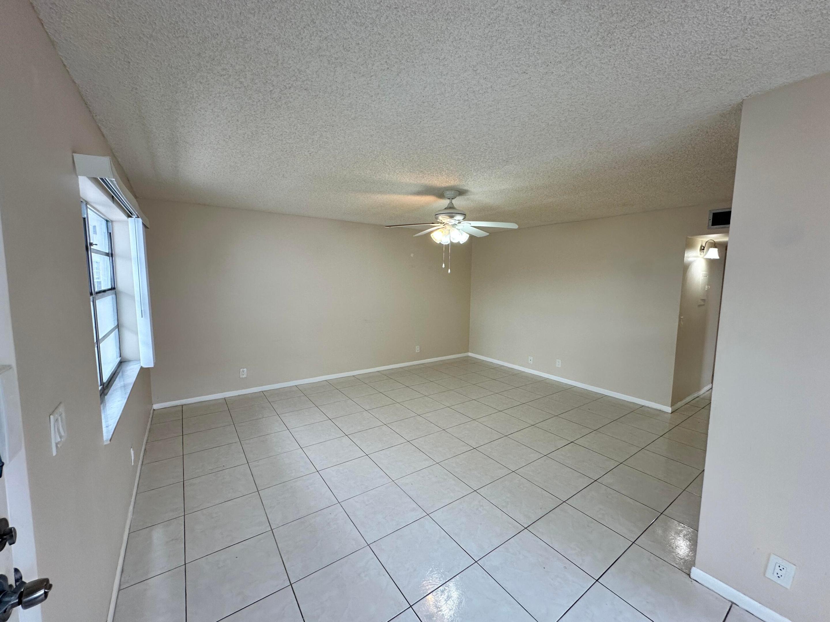 Spacious Living and Dining Area with Kitchen to the Left
