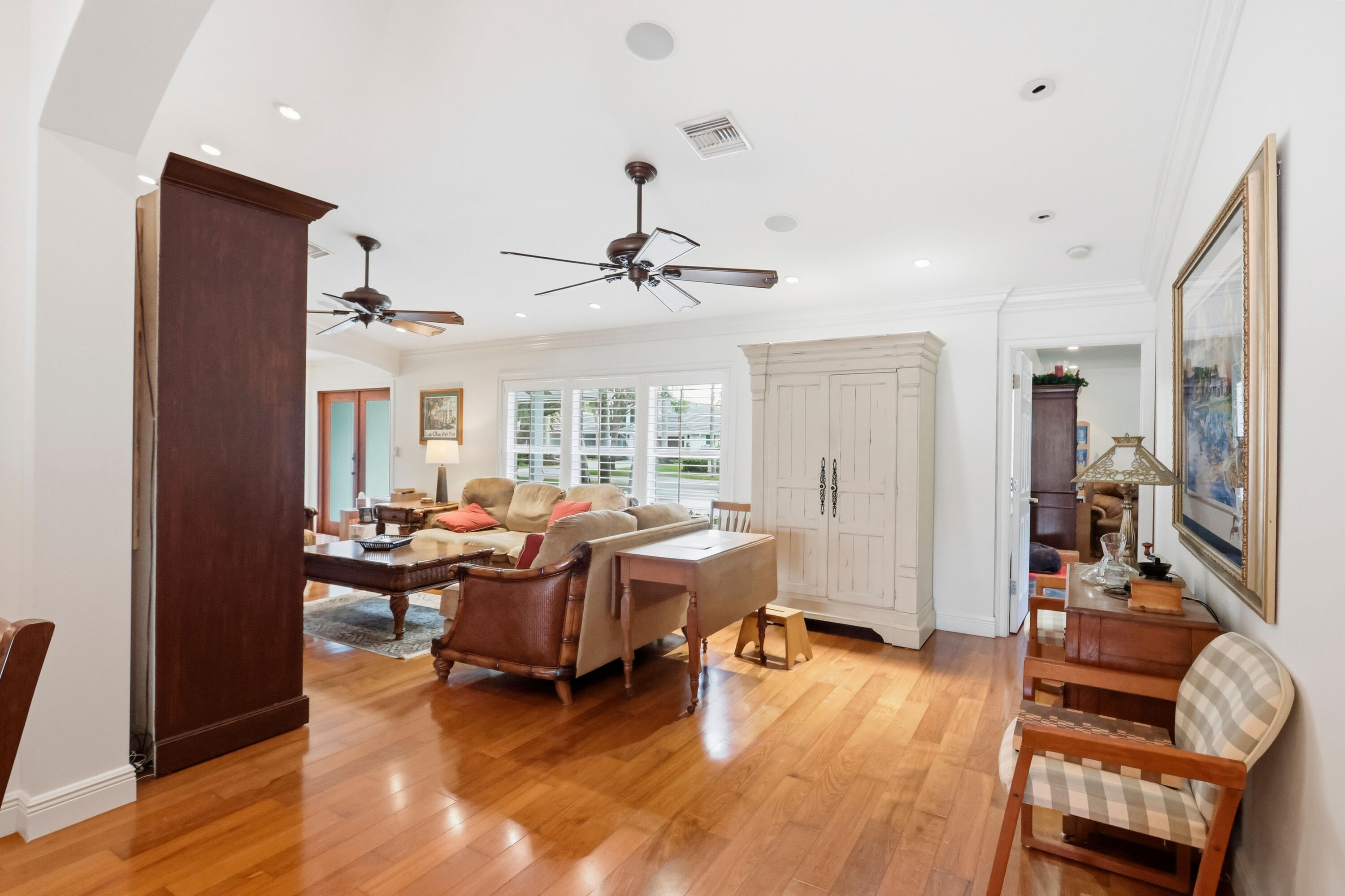 Hardwood flooring, recessed lighting, crown molding, ceiling fans, and multi-pane windows