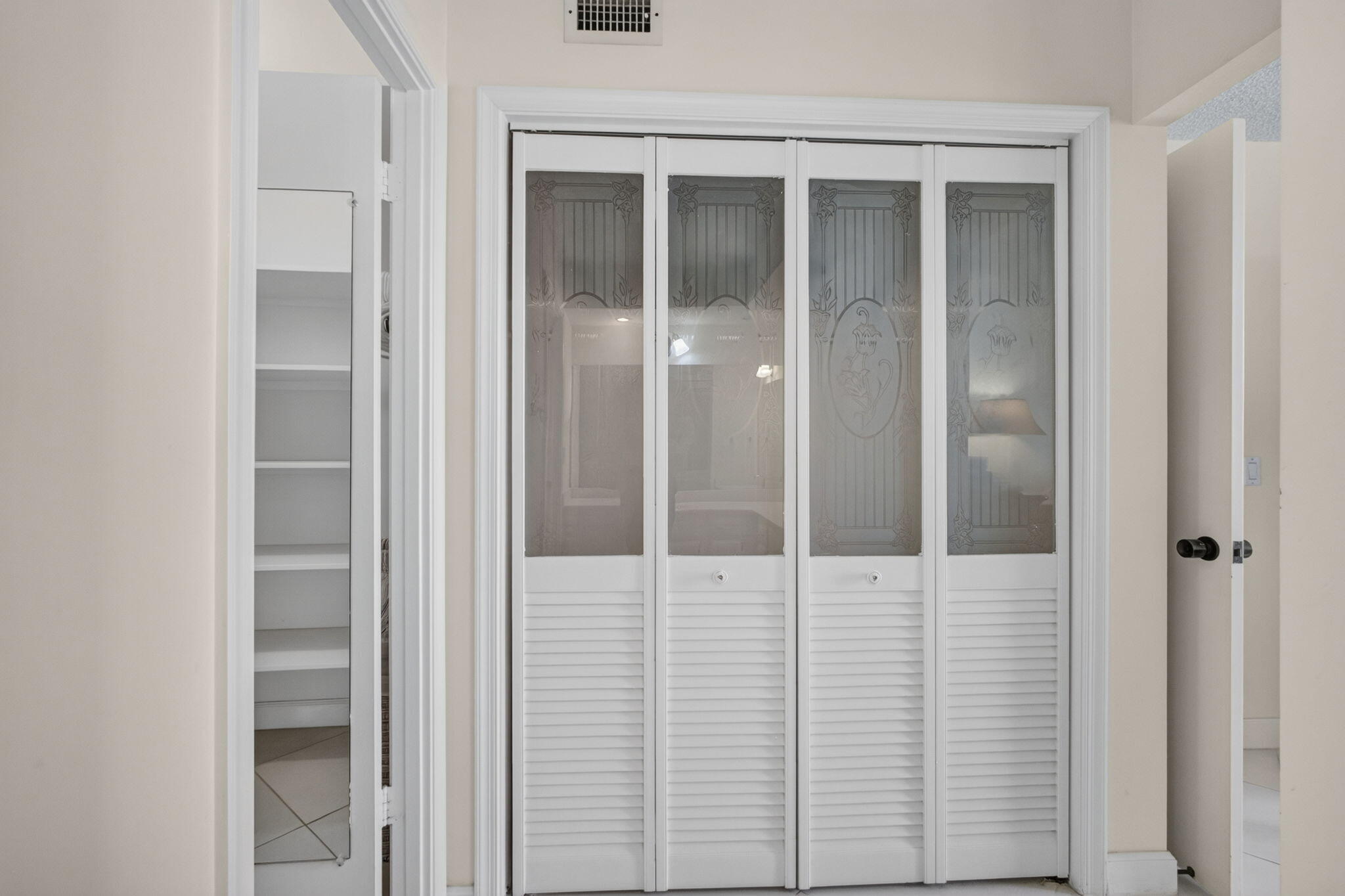 Primary Closet w/Venetian Bi-fold Doors