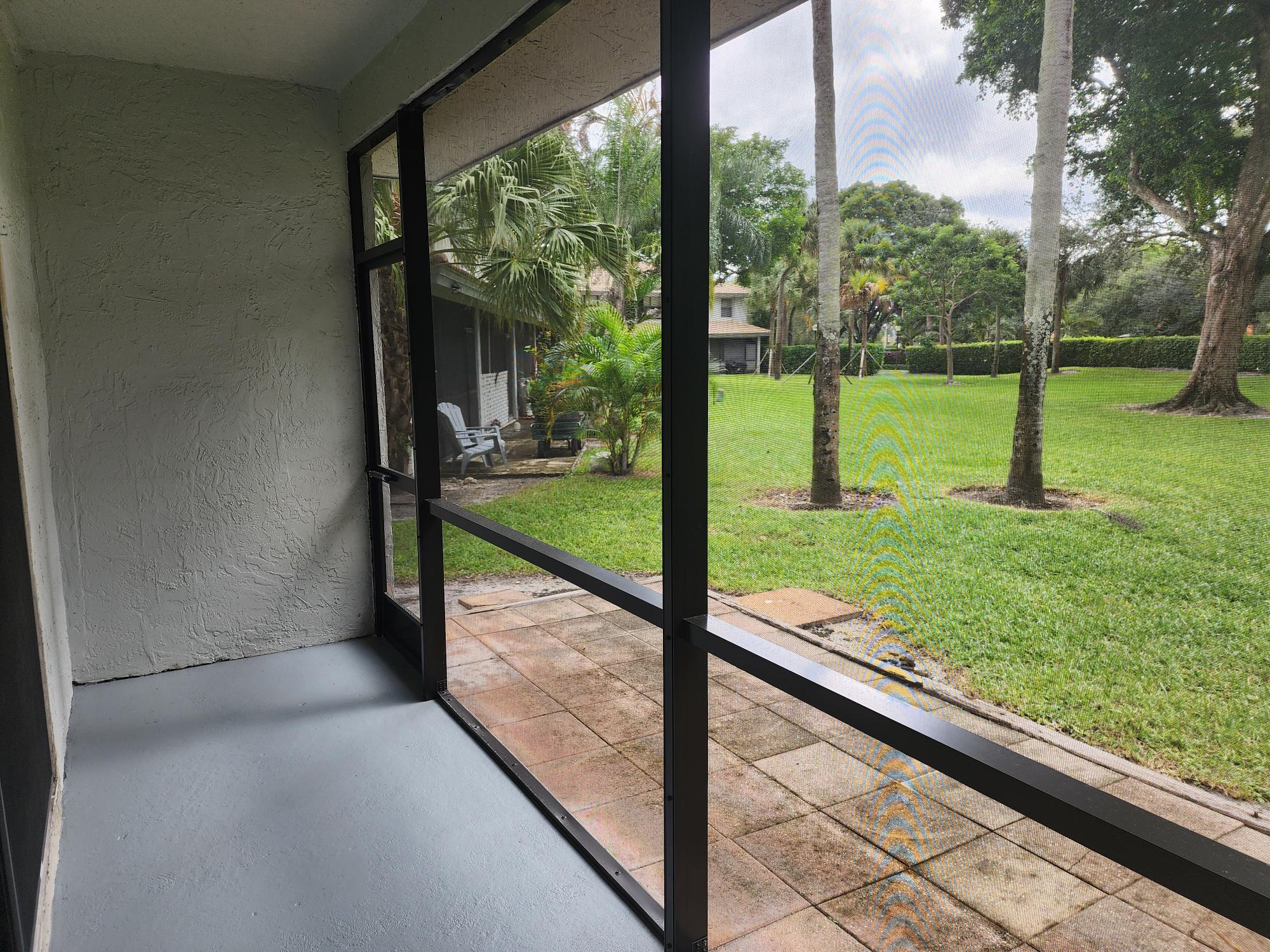 Back porch screen entrance with garden view