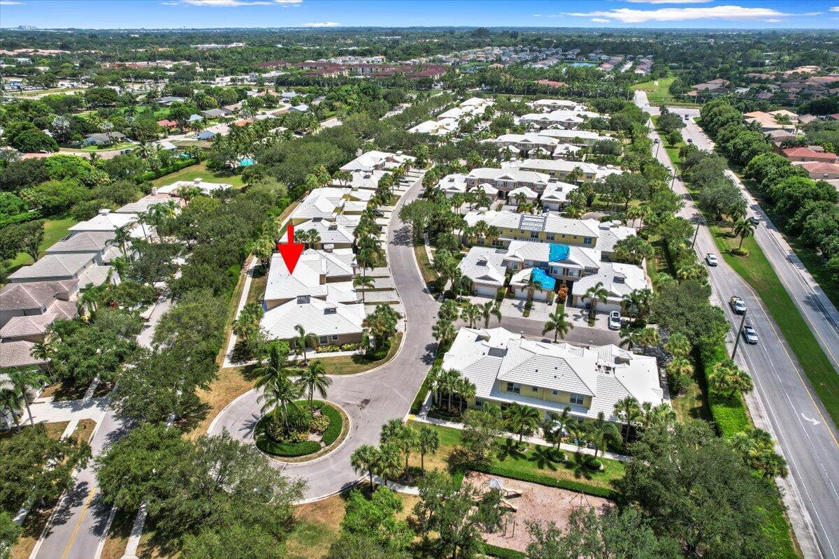 Aerial view highlighting the townhome's setting and nearby residential streets.