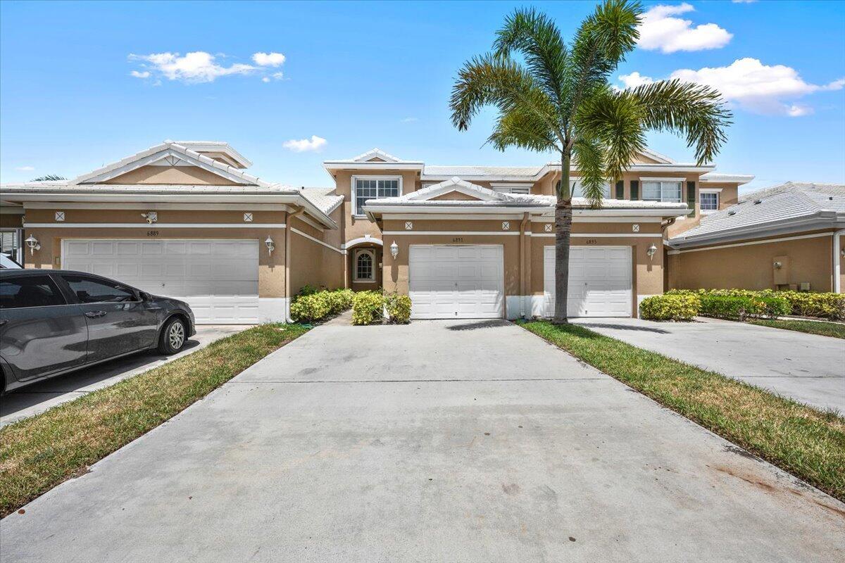 Attractive two-story townhome with an attached garage and welcoming entrance. Attractive two-story townhome with an attached garage and welcoming entrance.