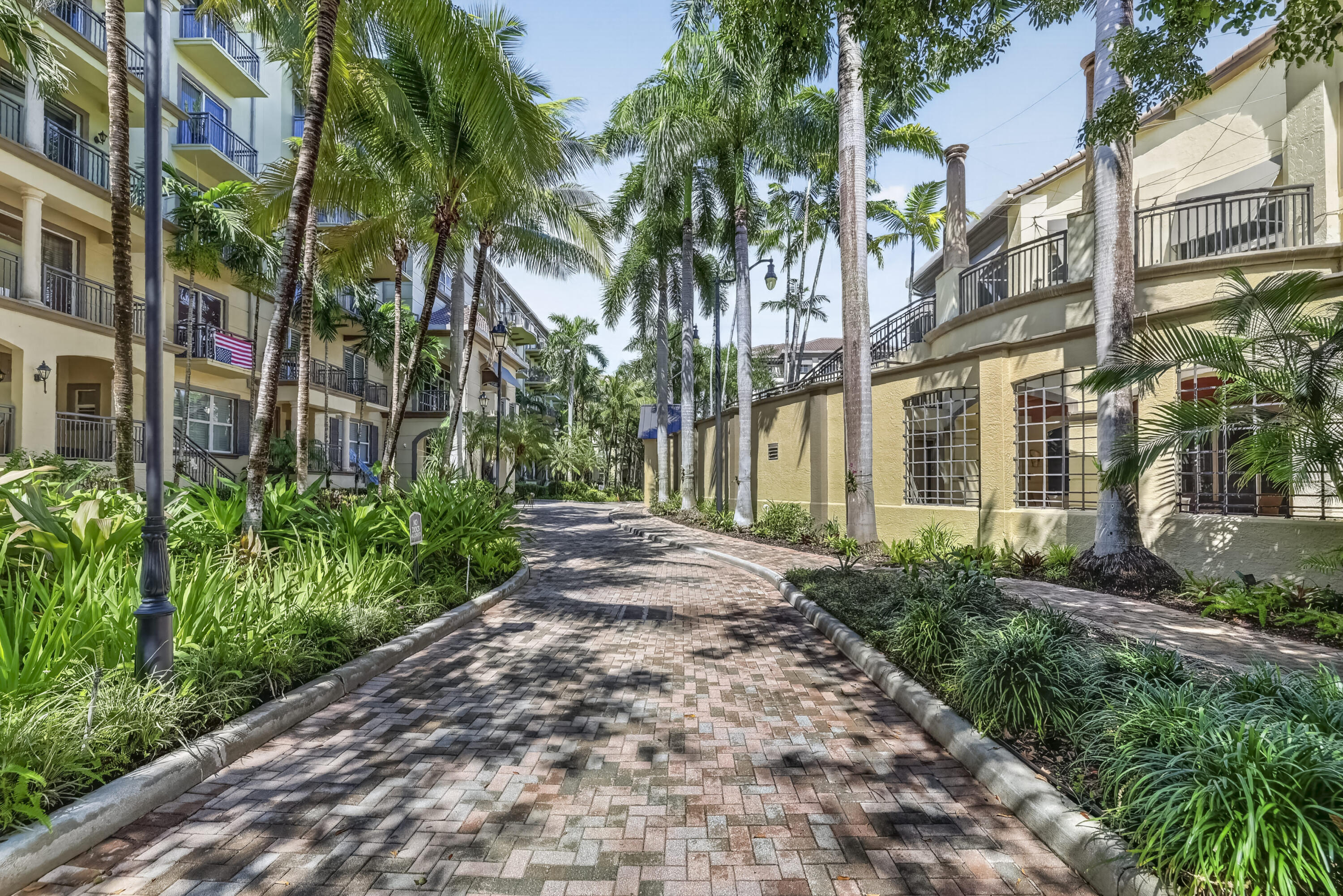 Village lane with beautiful landscaping & schaded sidewalks.