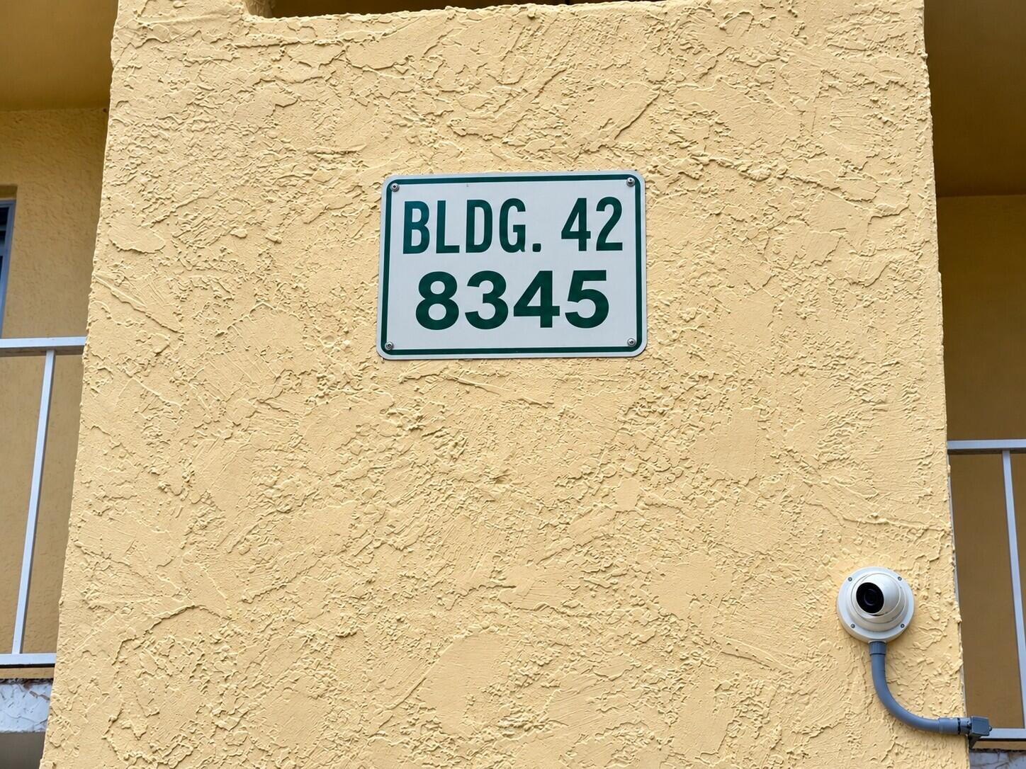 Building 42 Stucco Sign and Camera