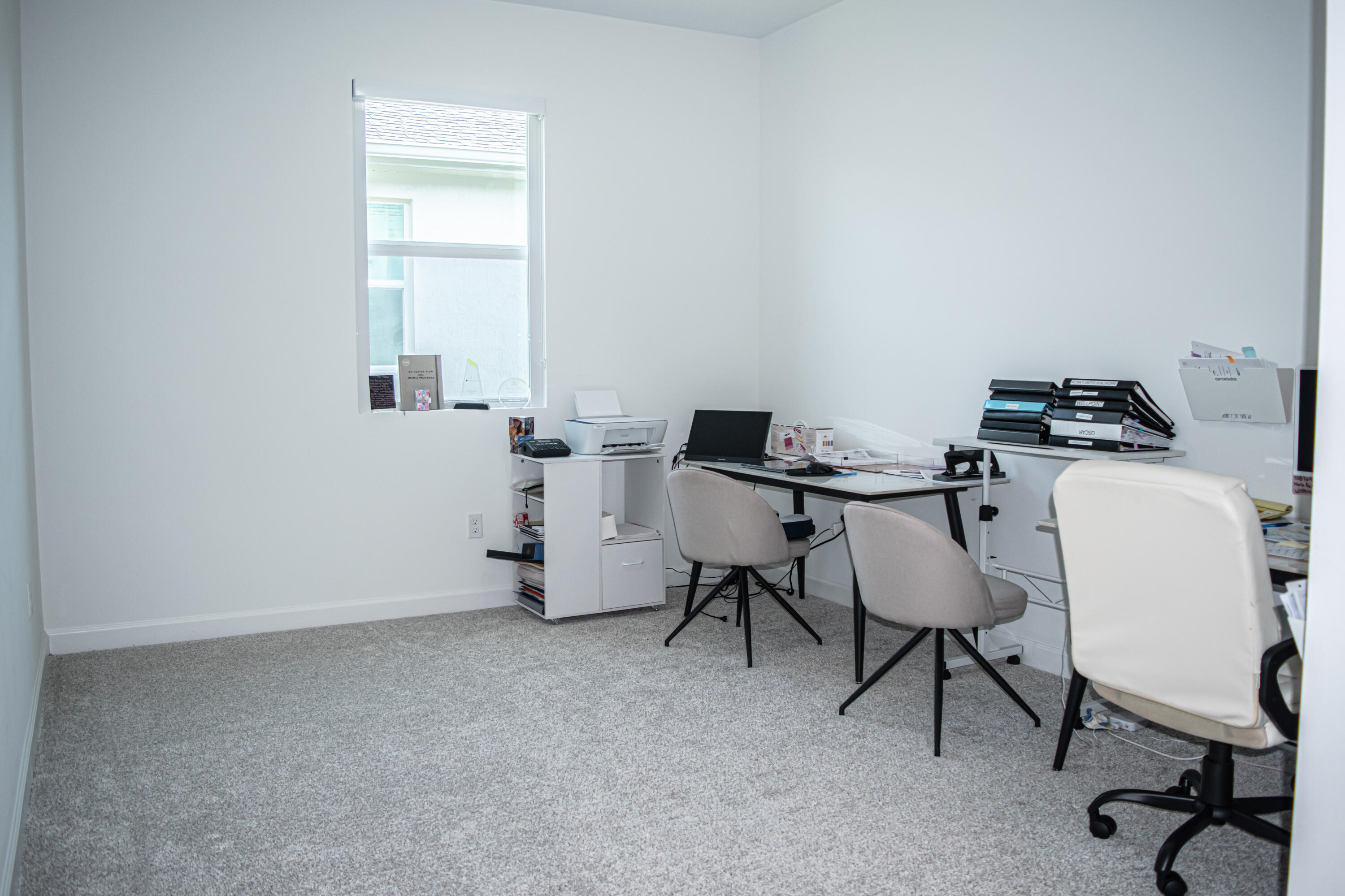 Neutral interior room featuring neutral carpeting and a single pane window