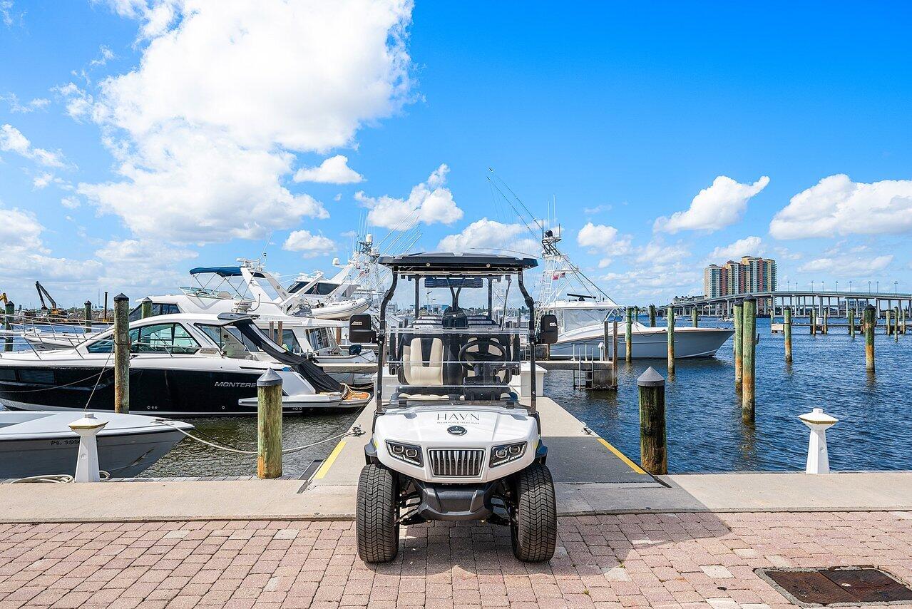 Paved concrete pier featuring deep-water boat slips and wood pilings