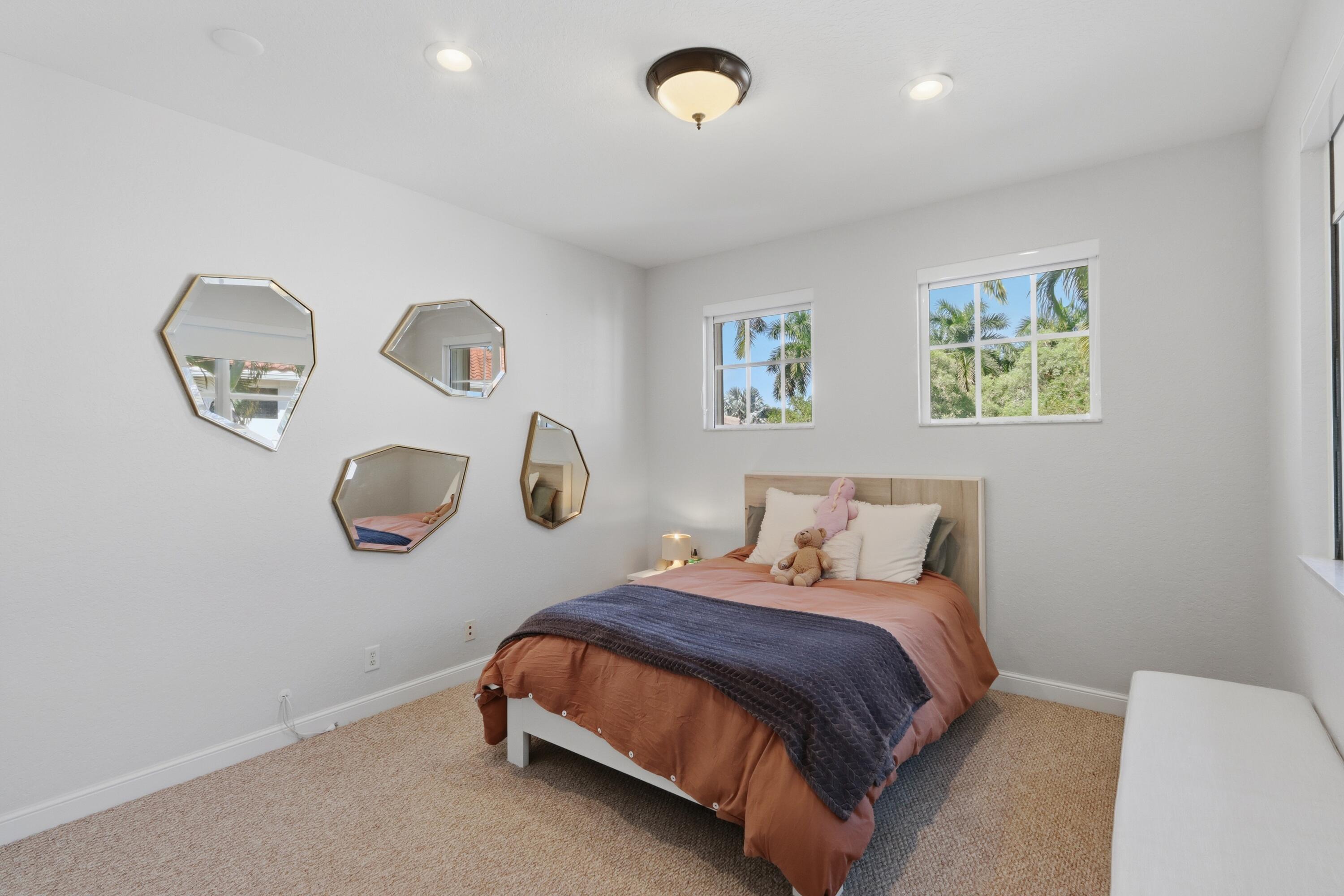 Neutral-toned interior featuring wall-to-wall carpeting, multi-pane windows, and recessed lighting
