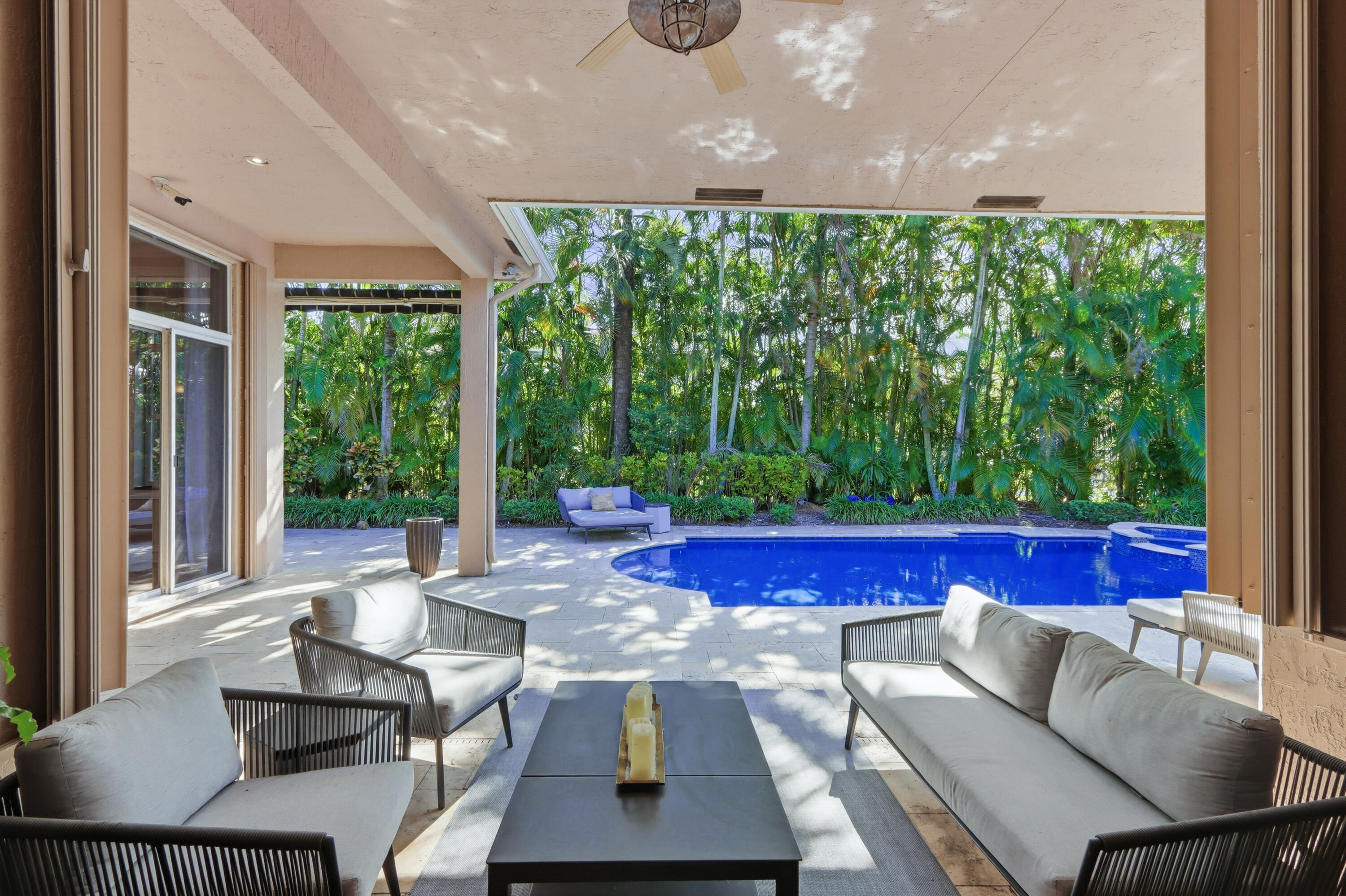 Covered patio featuring a ceiling fan, stone-style hardscaping, recessed lighting, and a pool with an integrated spa