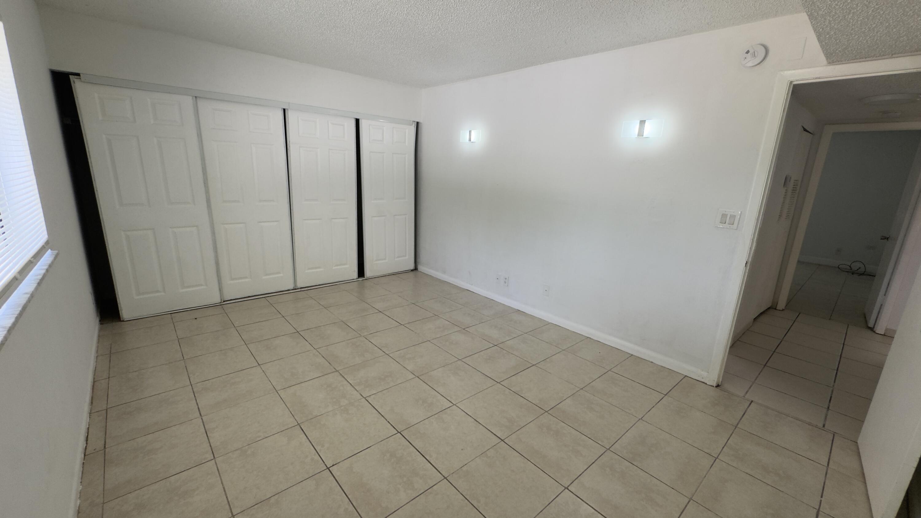Second bedroom with wall of closet spaces