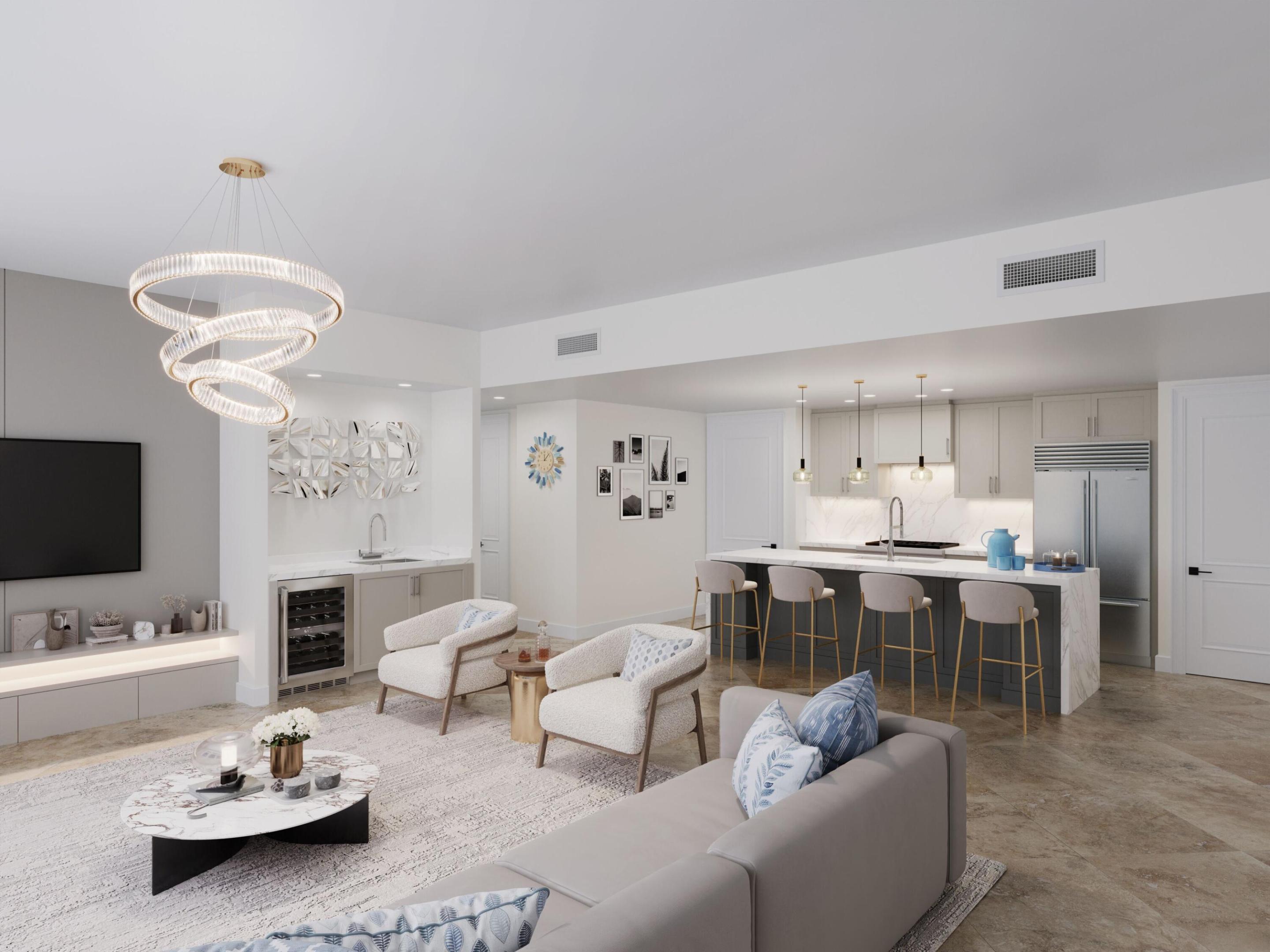 Open-concept interior featuring stone-finish flooring, a kitchen island with a waterfall-edge countertop, a built-in wet bar with an under-counter wine refrigerator, and a statement spiral chandelier Open-concept interior featuring stone-finish flooring, a kitchen island with a waterfall-edge countertop, a built-in wet bar with an under-counter wine refrigerator, and a statement spiral chandelier