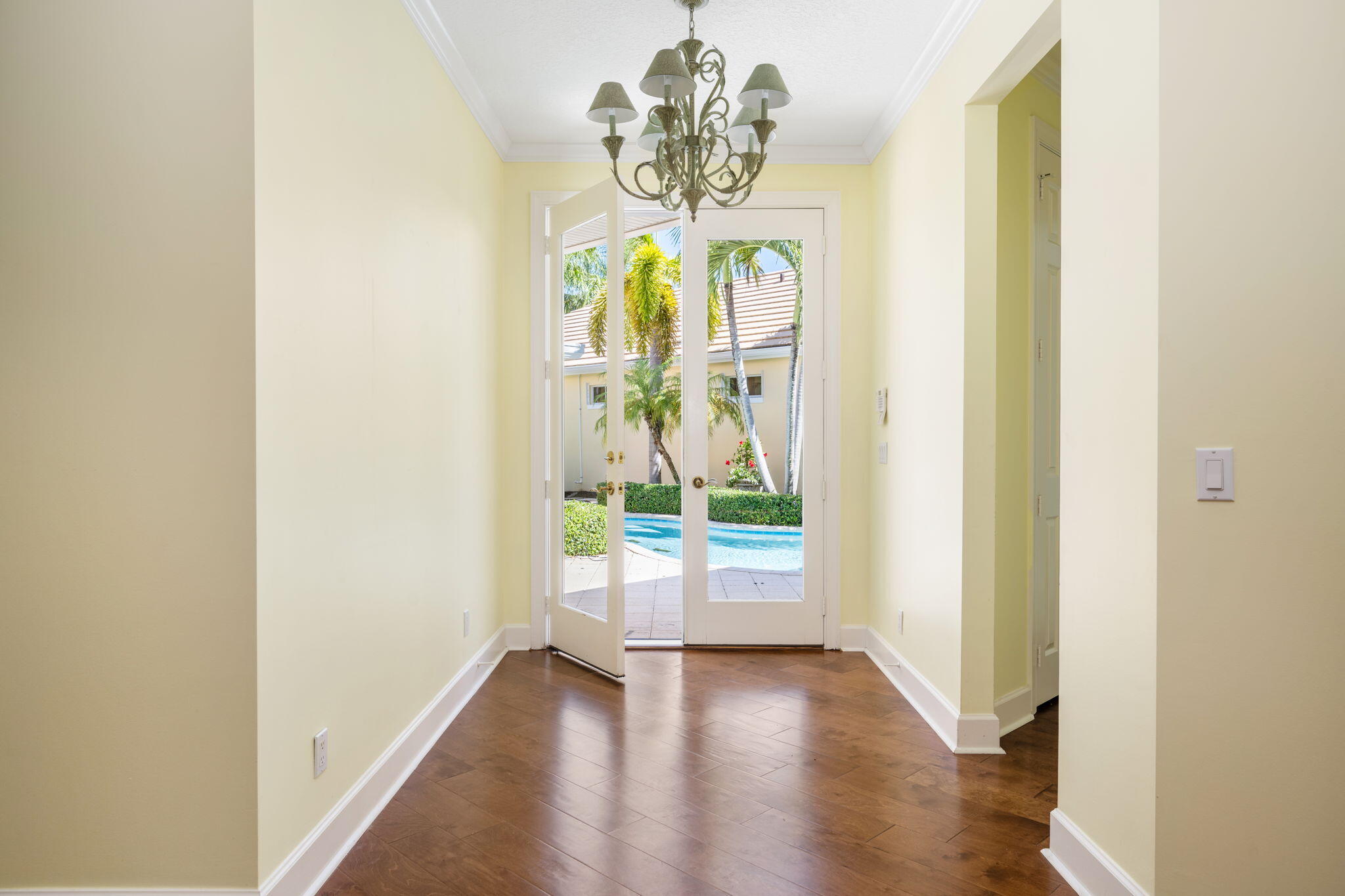 lovely front glass doors open to foyer and expanded living room. Fantastic courtyard pool views
