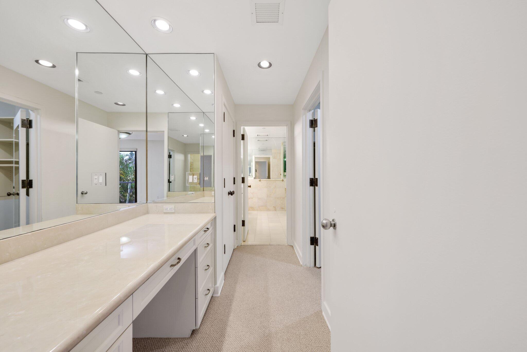 Primary Suite Makeup Area/Multiple Closets/Path to His/Her En-Suite Bathroom