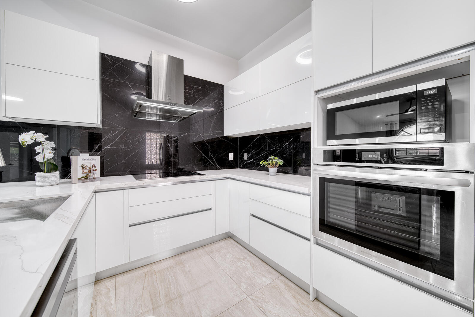 High-end stainless steel appliances include a built-in oven, cooktop, and microwave.