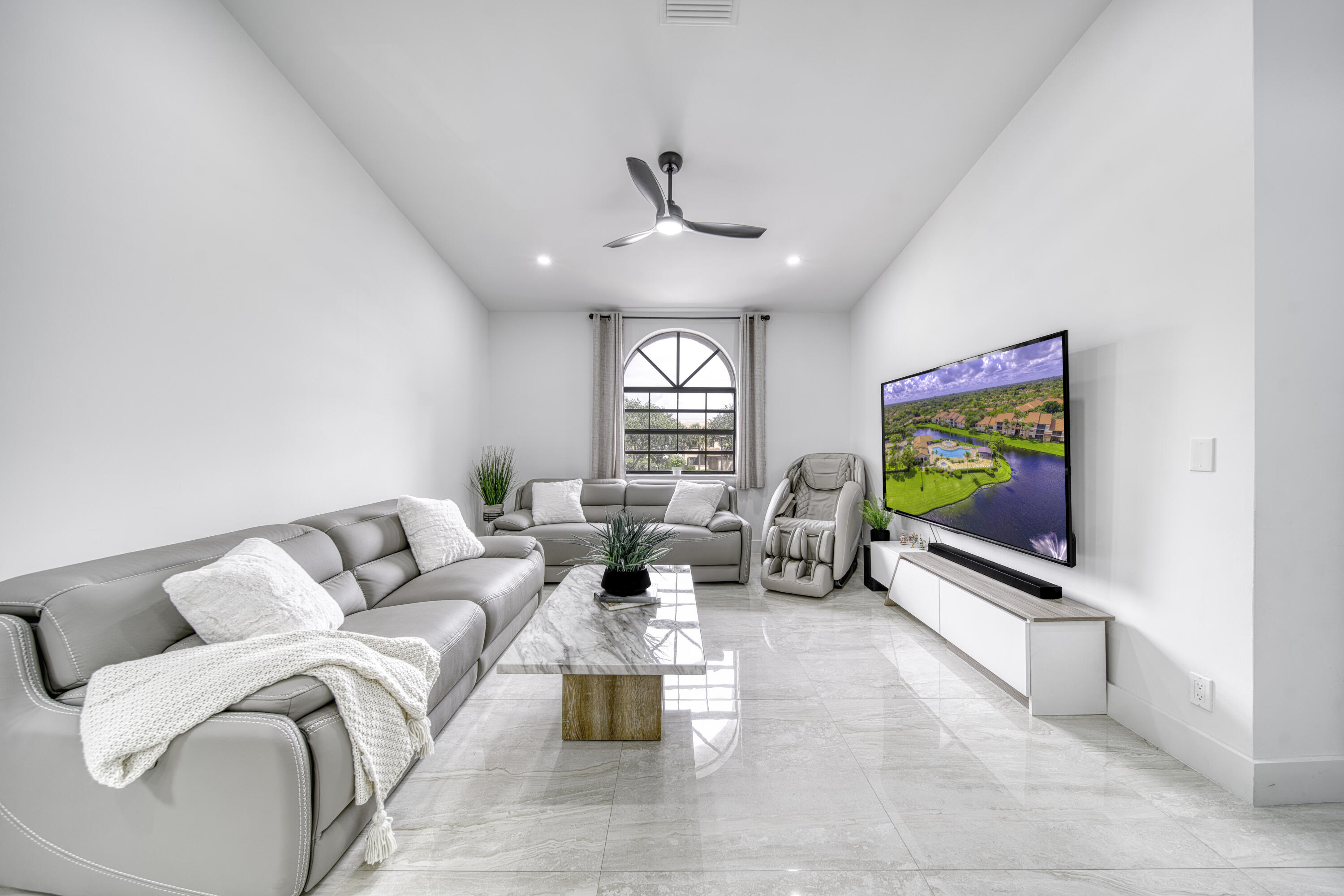 Large-format porcelain tile and recessed lighting throughout.