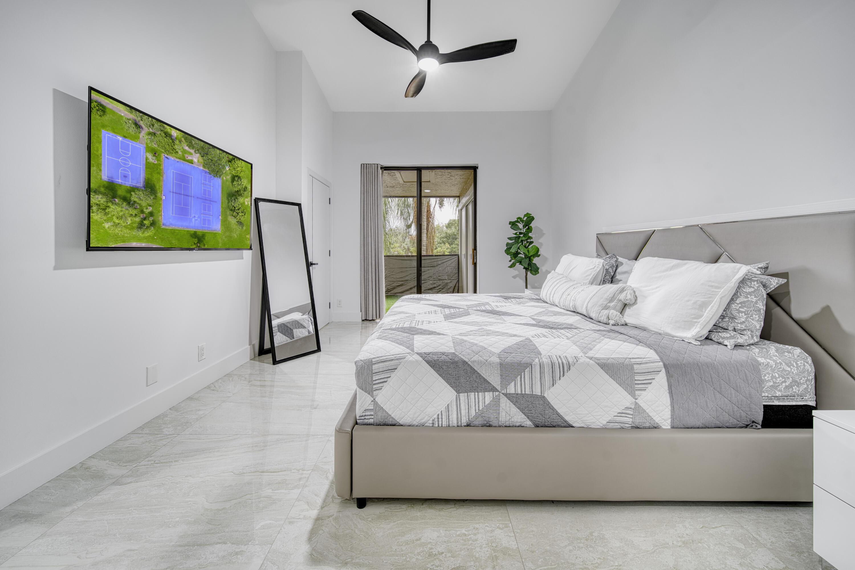 Spacious primary bedroom with abundant natural light.