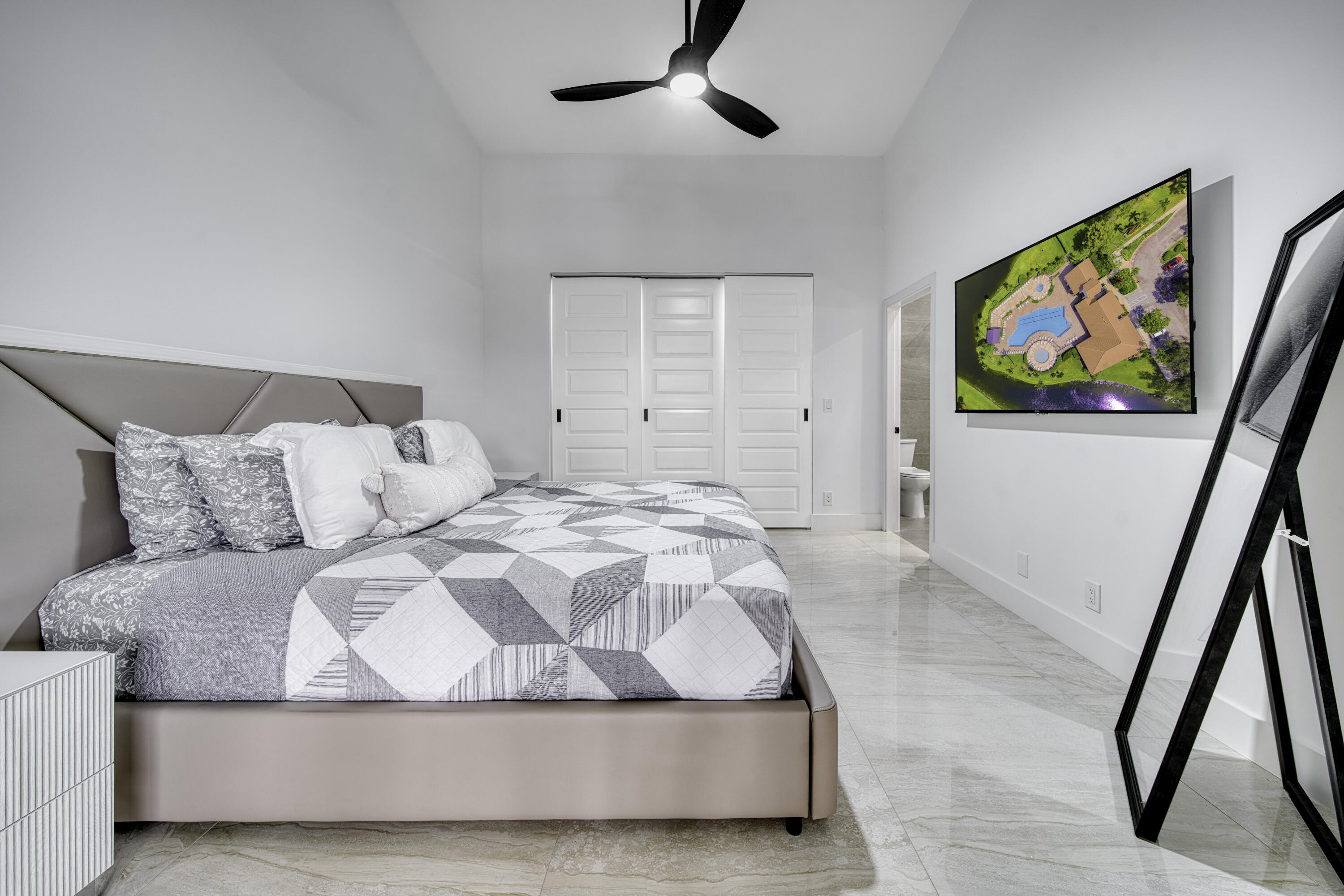 Spacious primary bedroom with abundant natural light.