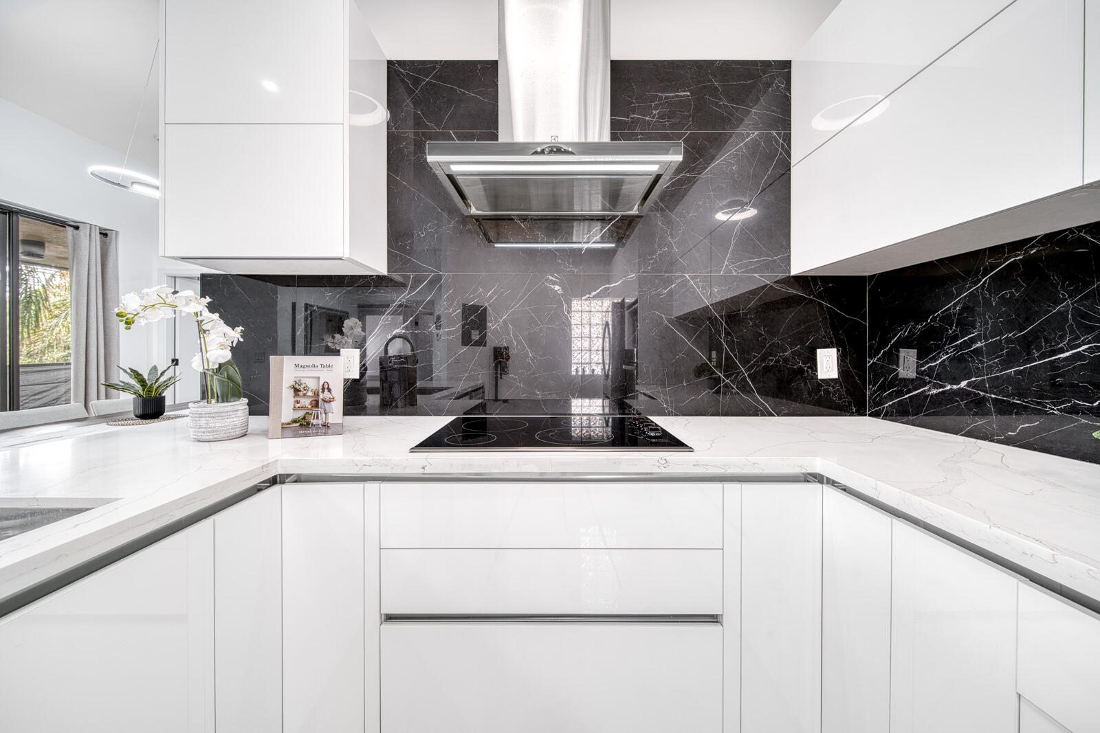 Porcelain tile backsplash and sleek cabinetry complete the contemporary design.