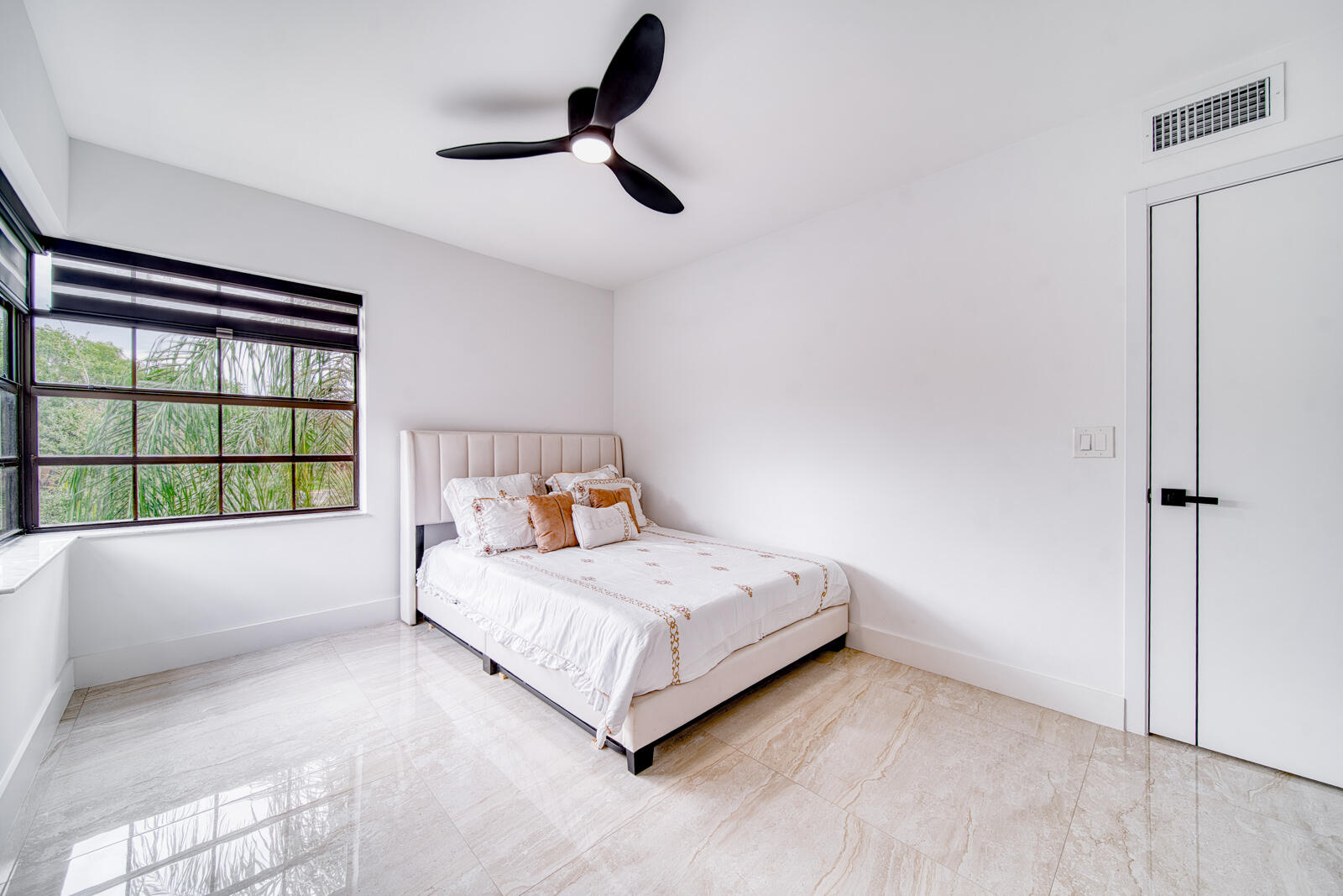 Porcelain tile flooring and zebra blinds.
