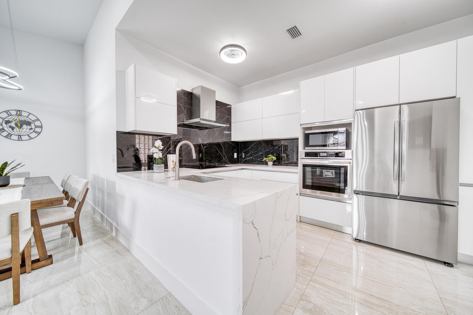 Custom Gola-style cabinetry, quartz countertops, and a waterfall island highlight