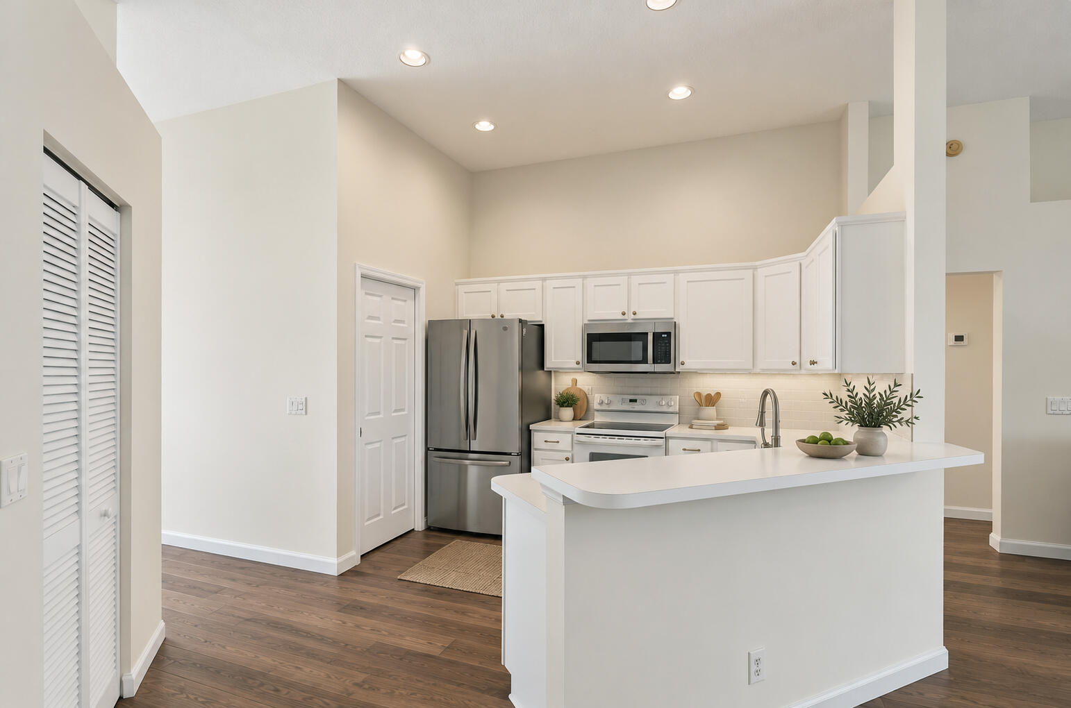 VIRTUALLY STAGED. Kitchen shown with digitally updated paint and floors to illustrate a light refresh.
