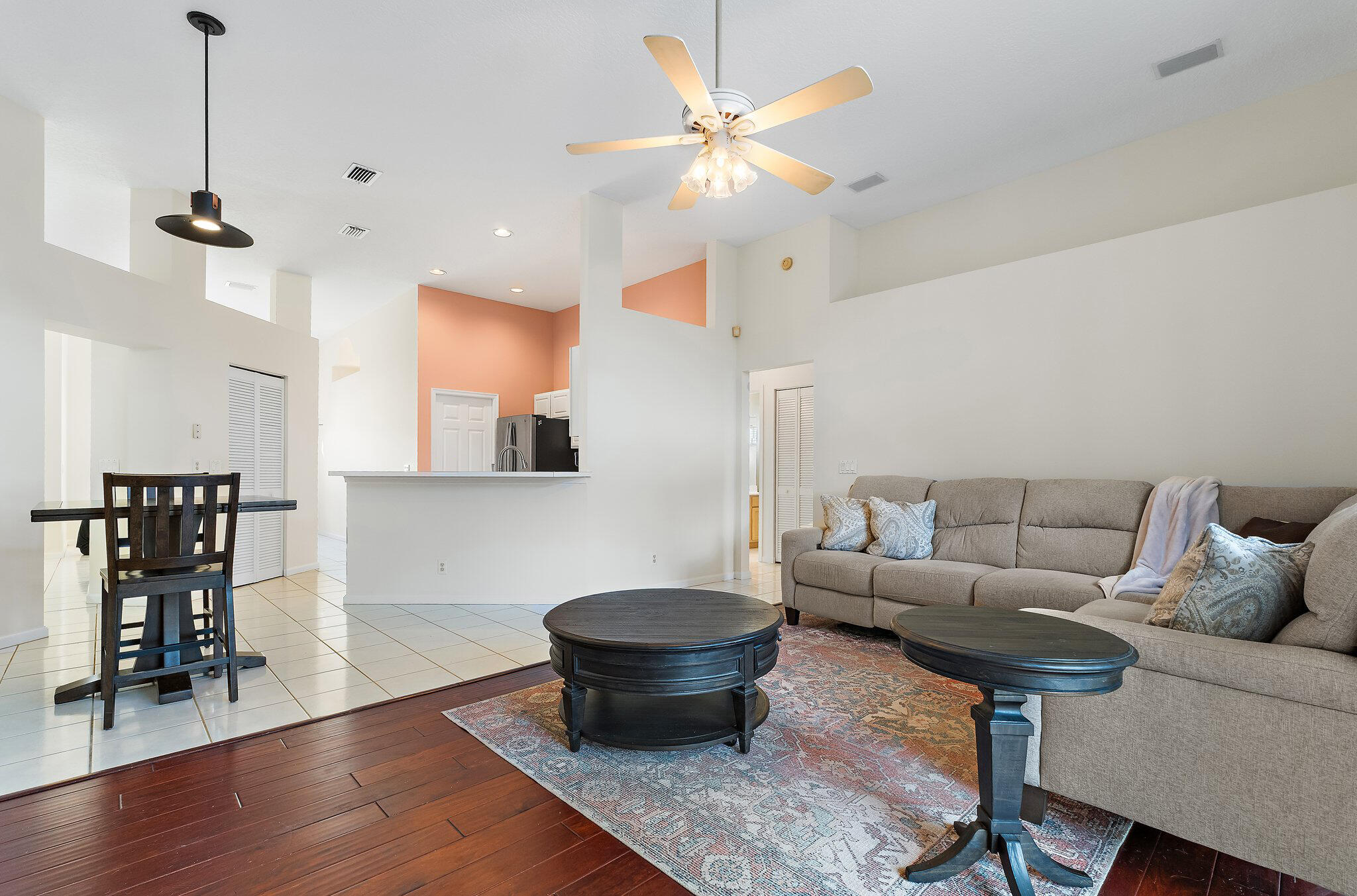 Open family room and dining area with wood floors.