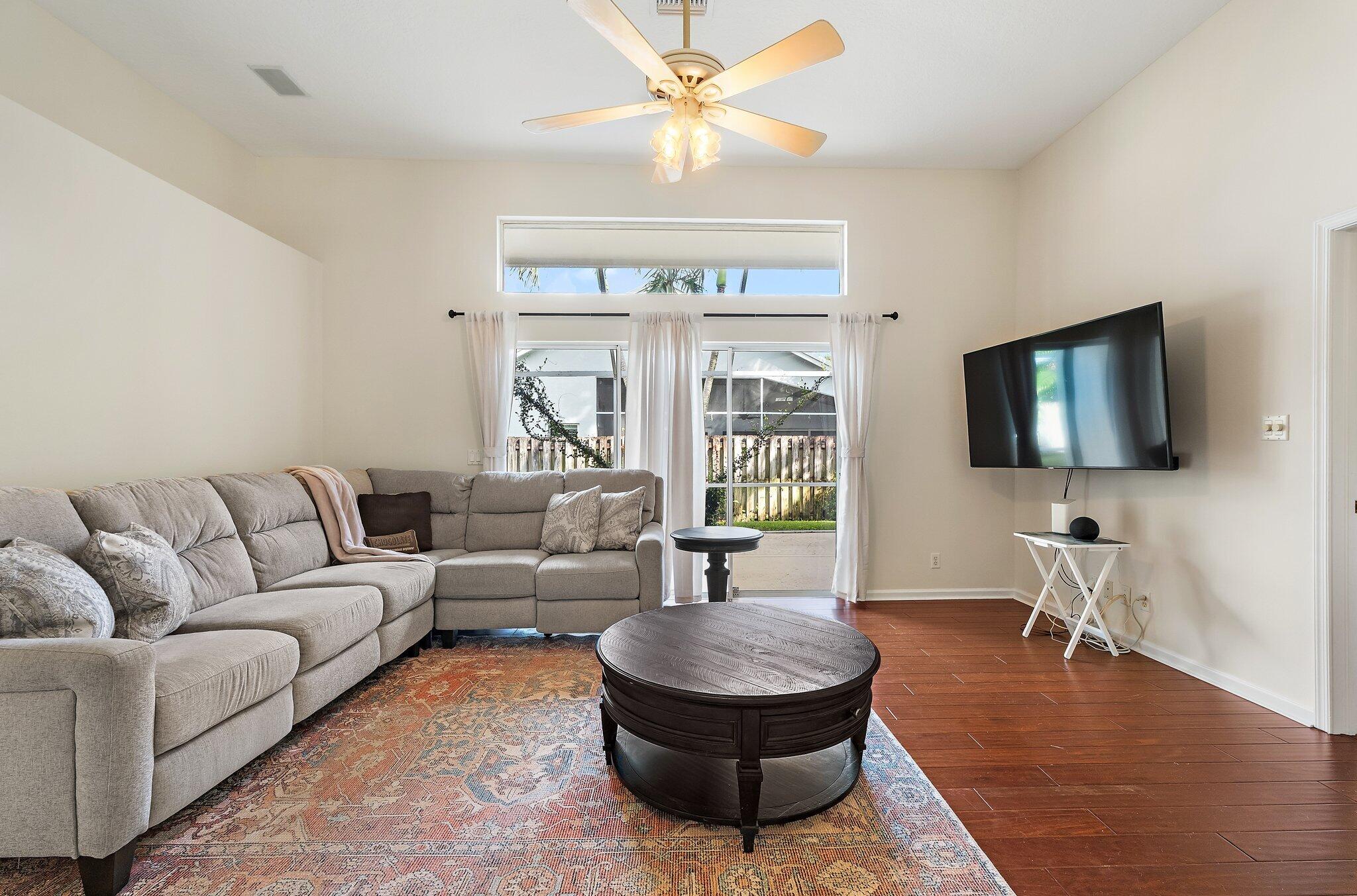 Family room with high ceilings and a ceiling fan.