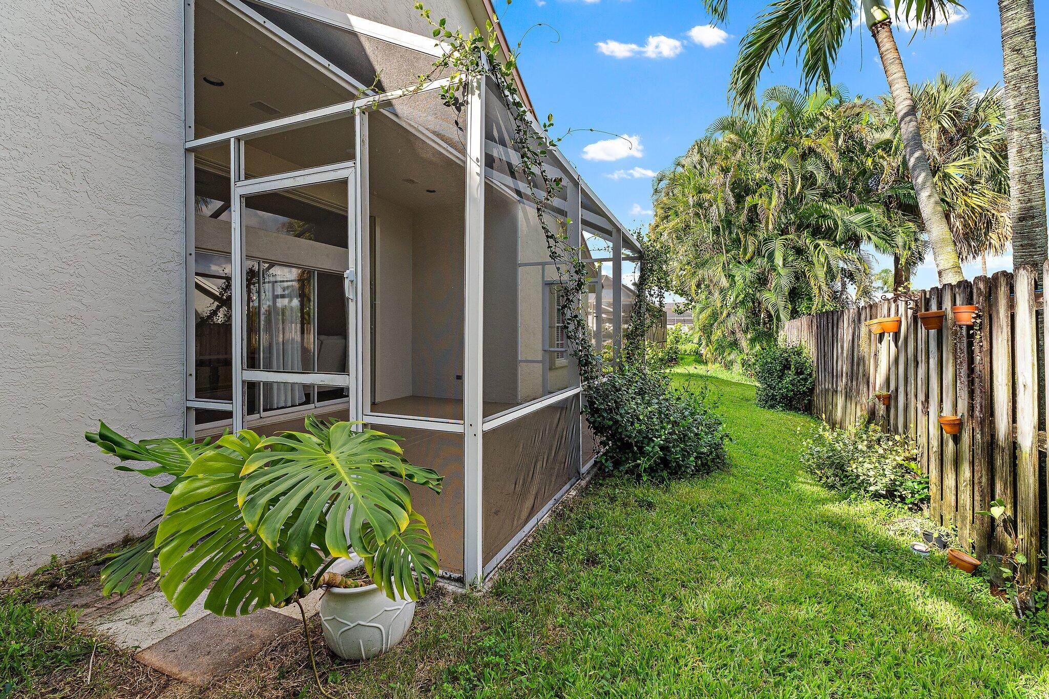 Fenced backyard and the outside of the screened patio.