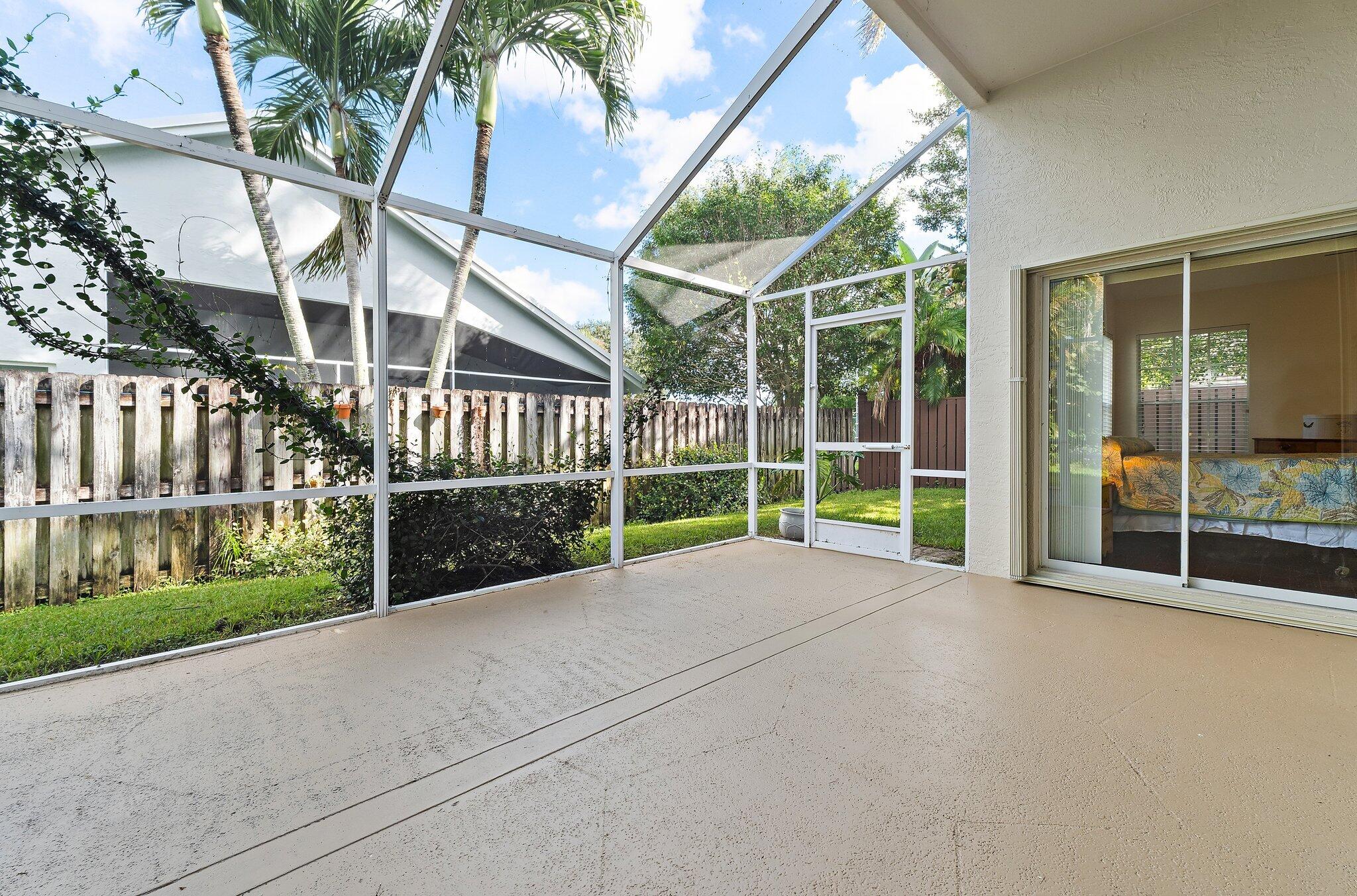 Screened patio with sliding glass doors to the primary bedroom and living room.
