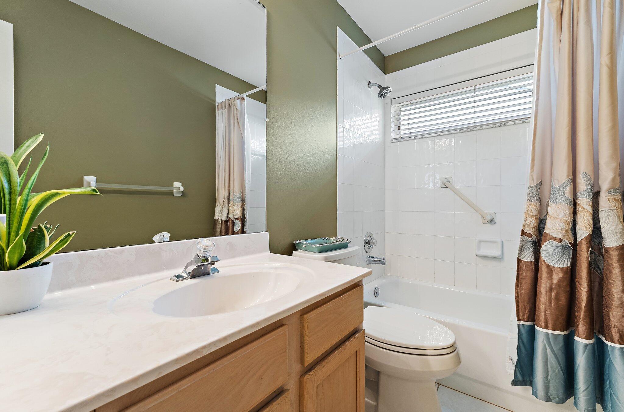 Guest bathroom vanity and tub.