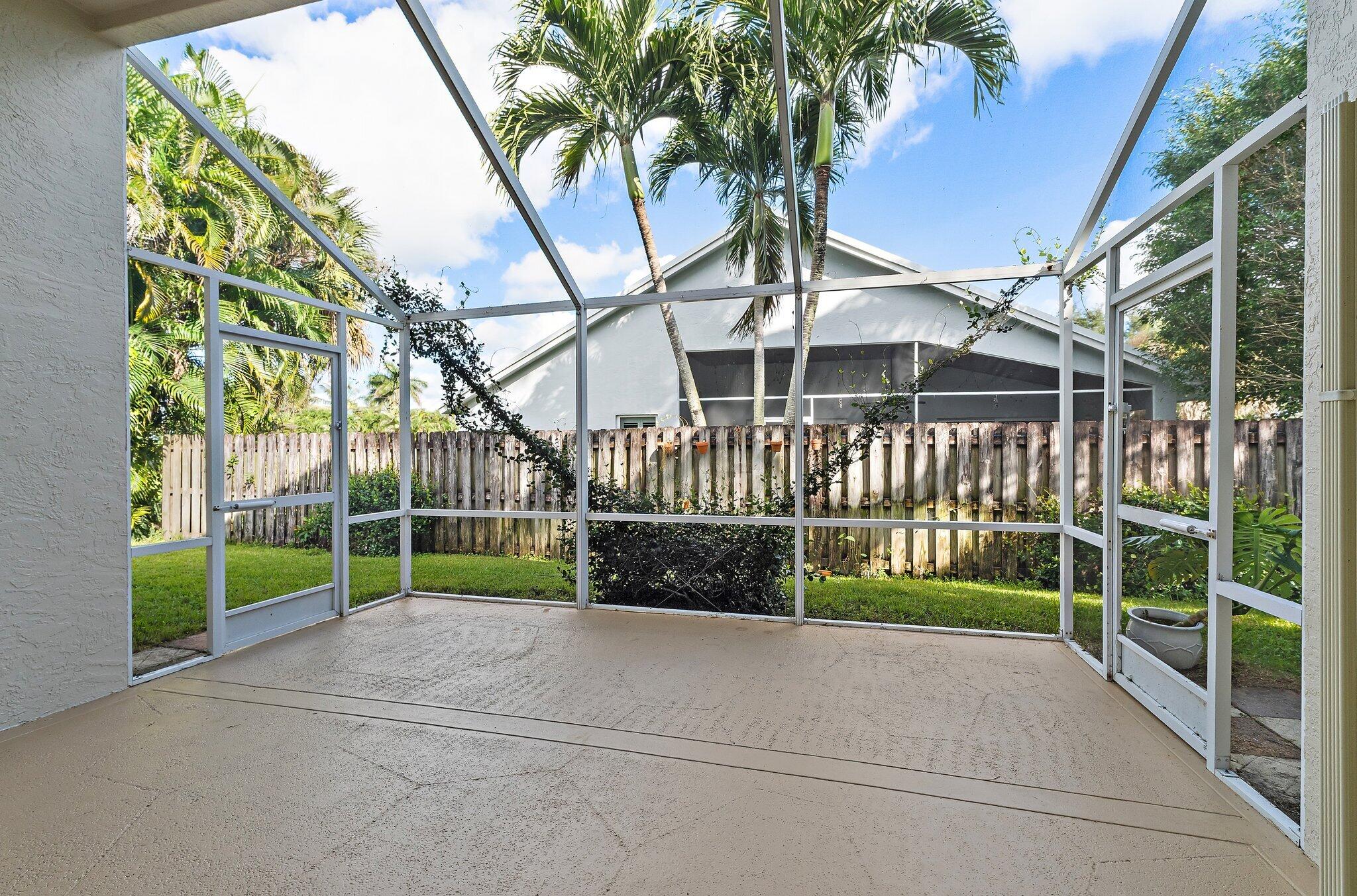 Screened patio overlooking the fenced backyard.
