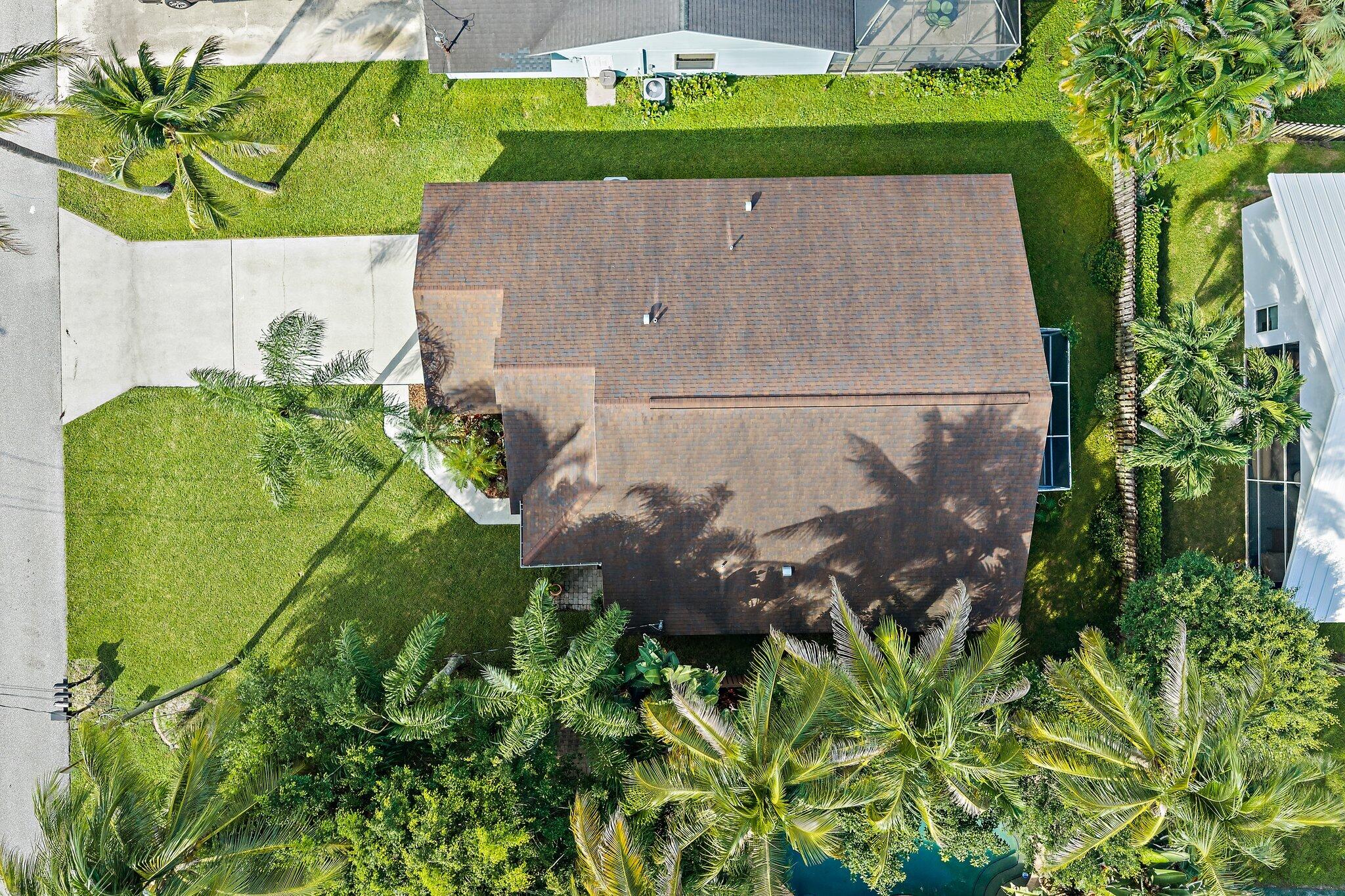 Overhead aerial of the home, yard and mature palms.