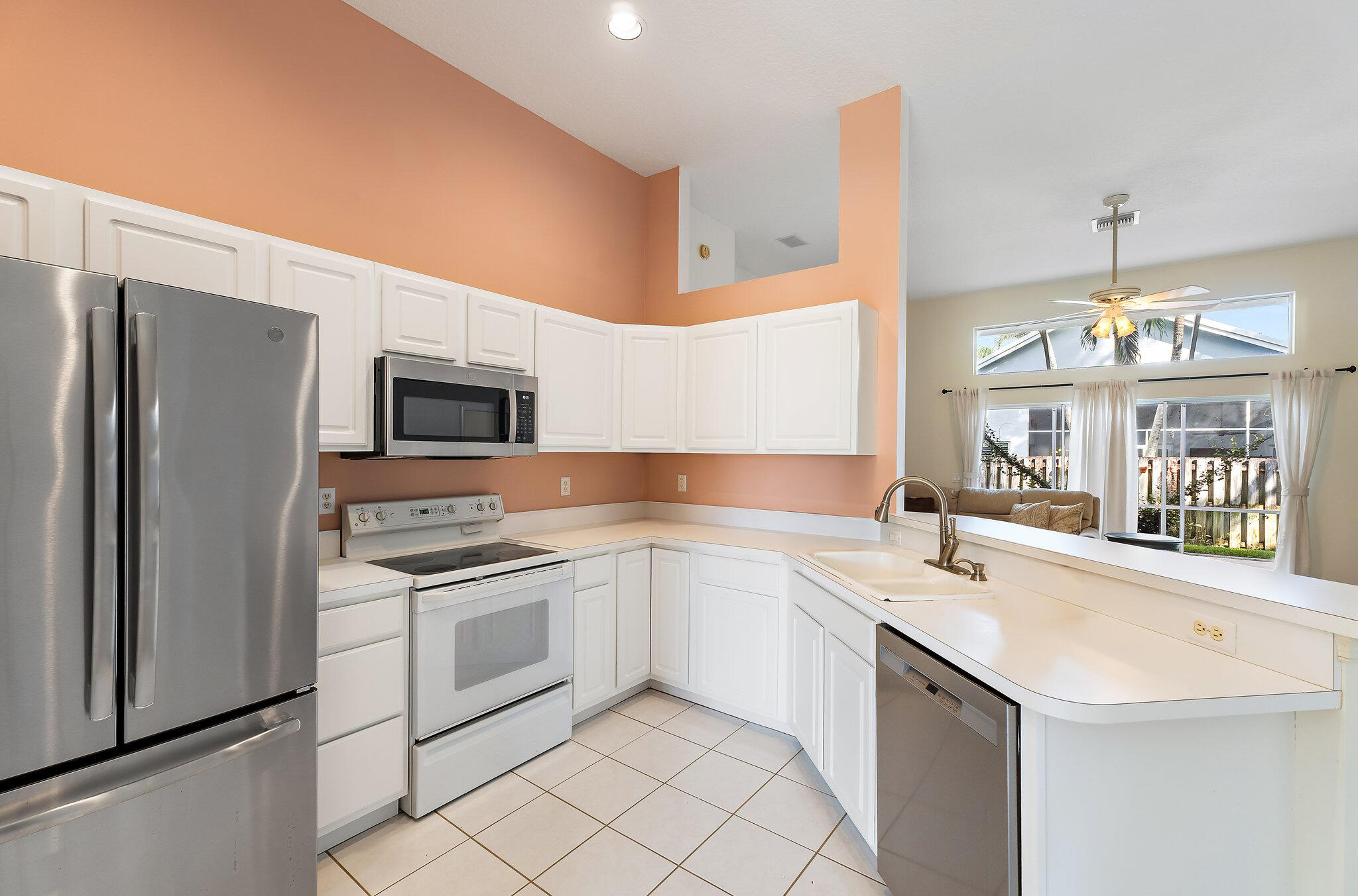 Kitchen with stainless appliances and a window over the sink.