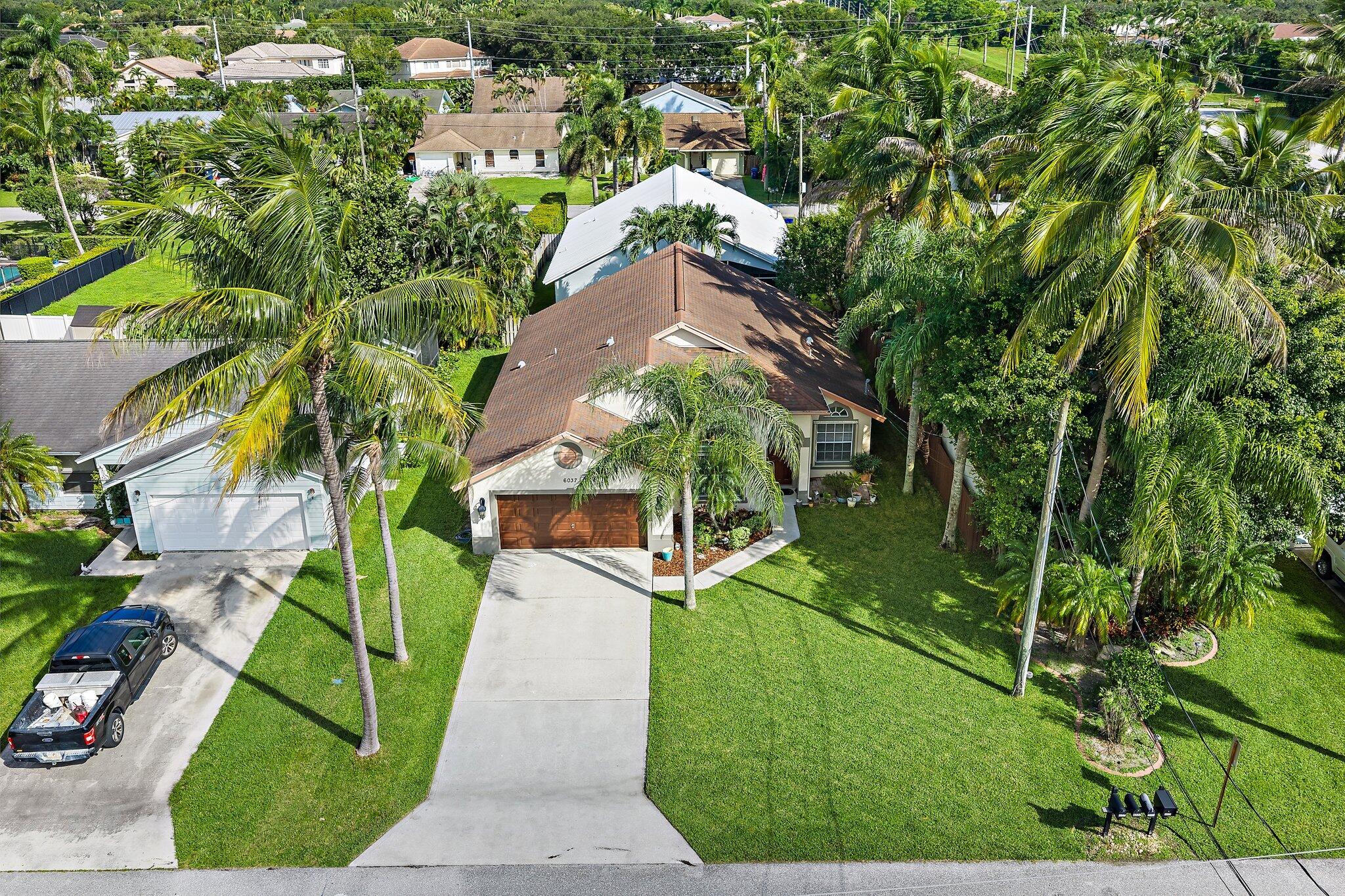 Aerial view of the front of the home and driveway.