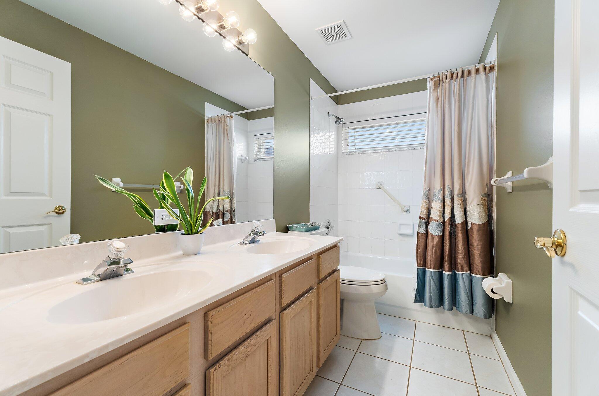Guest bathroom with a vanity and tub with shower.