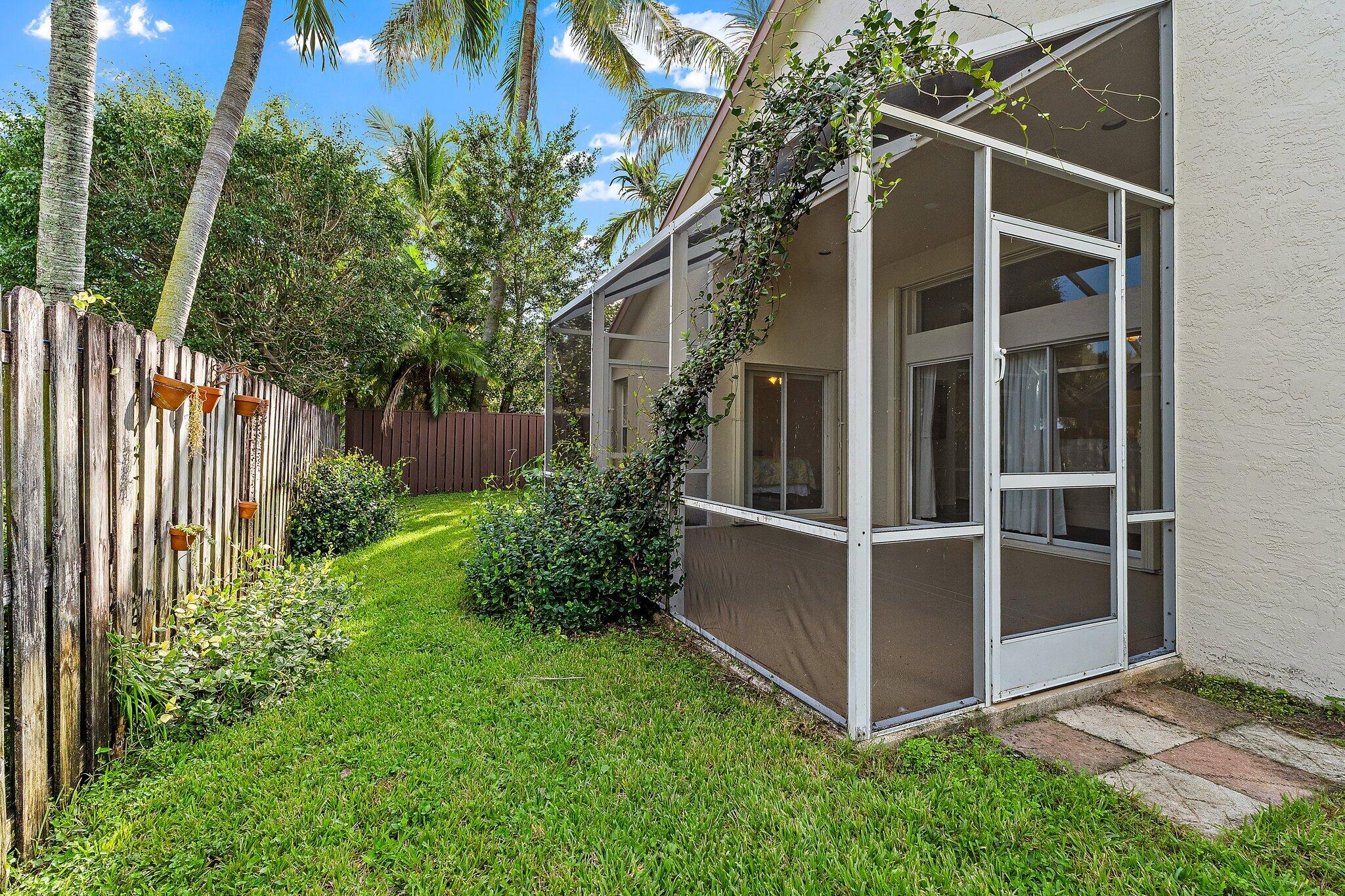 Backyard with privacy fence and screened patio.