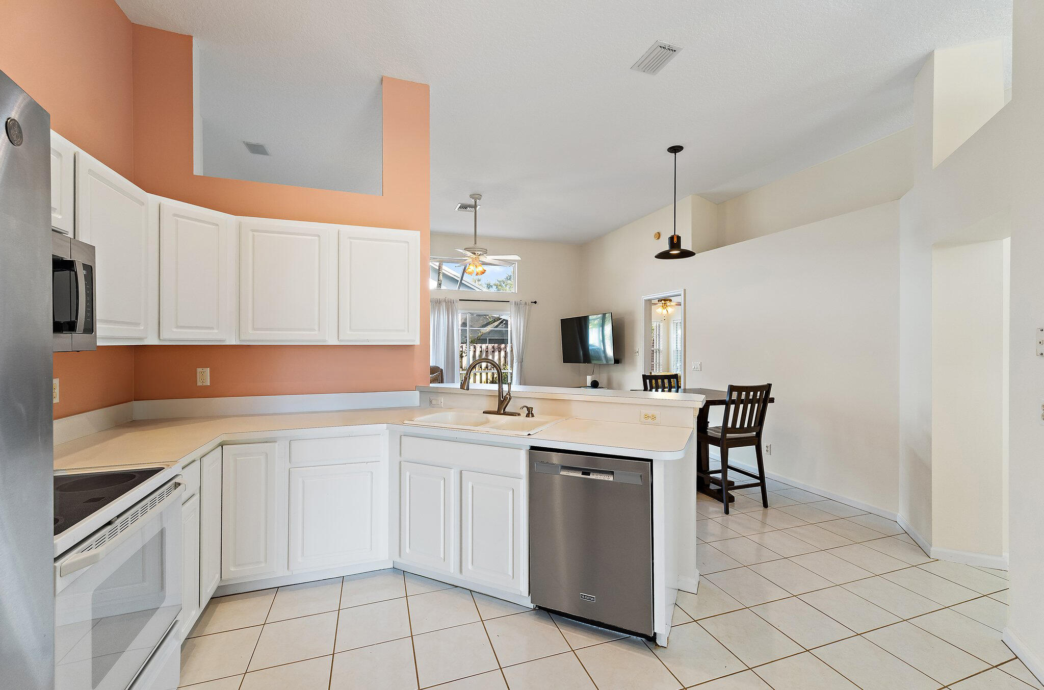 Kitchen with a breakfast bar open to the dining area.