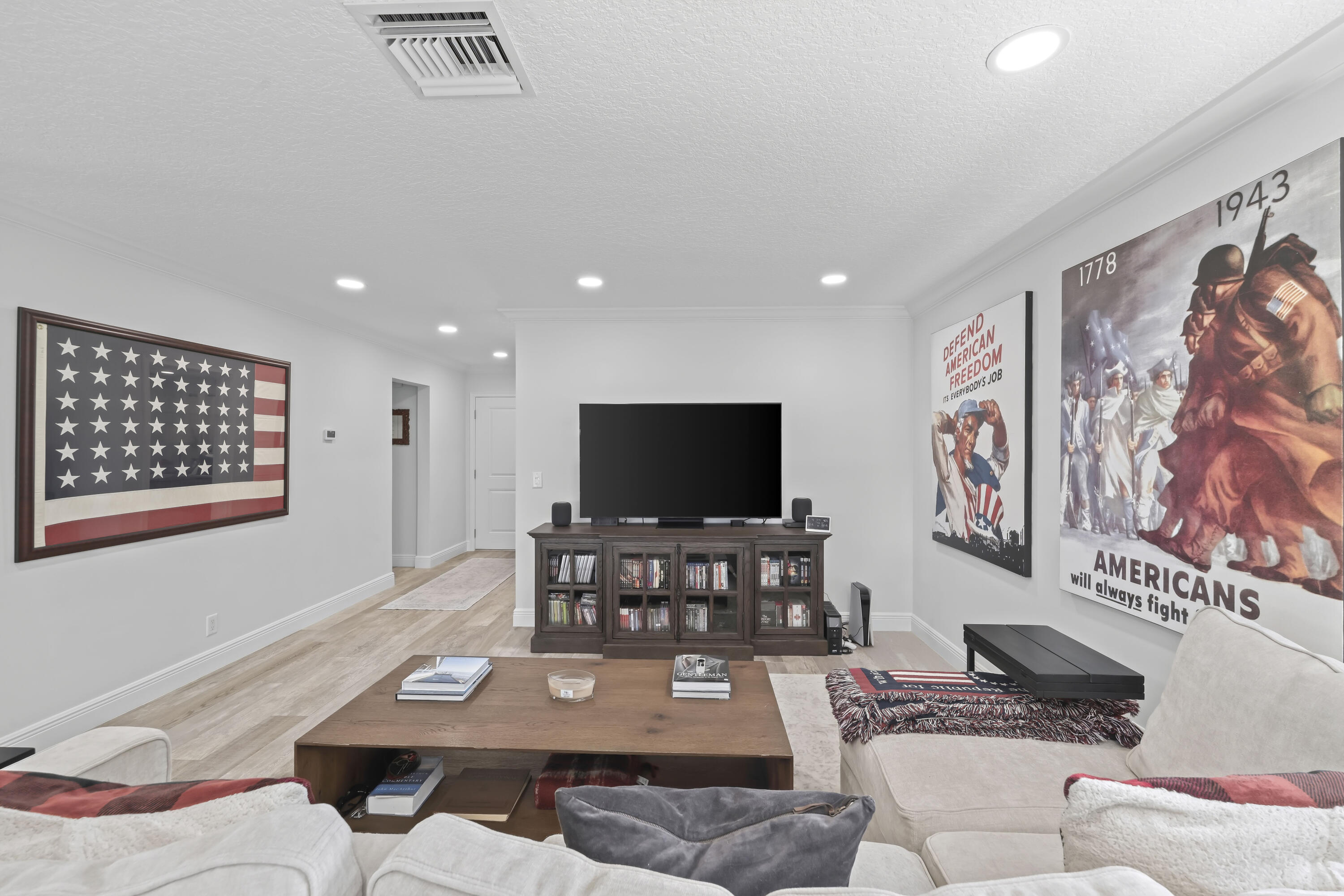 Living area featuring wood-finish flooring, recessed lighting, and neutral wall tones