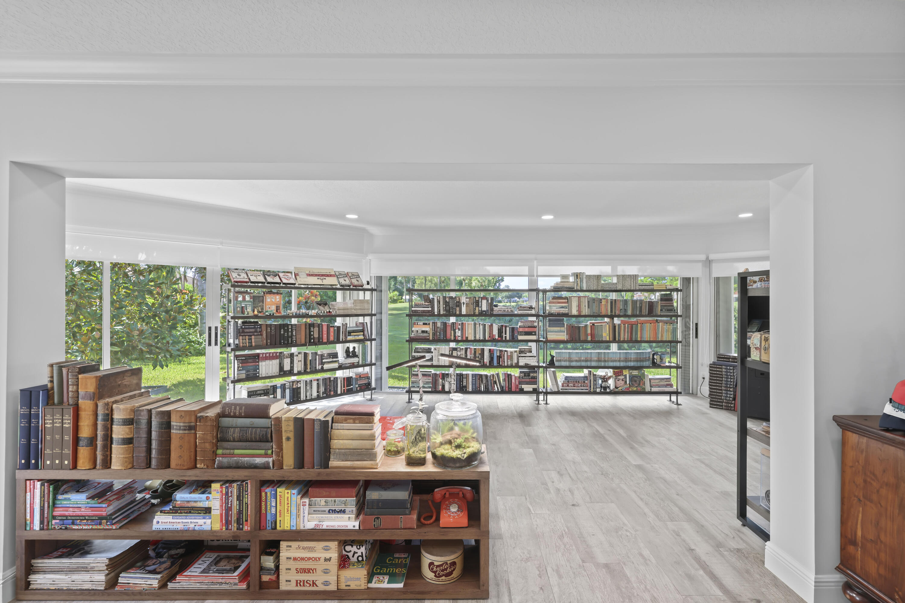 Wood-finish flooring, recessed lighting, and extensive floor-to-ceiling windows