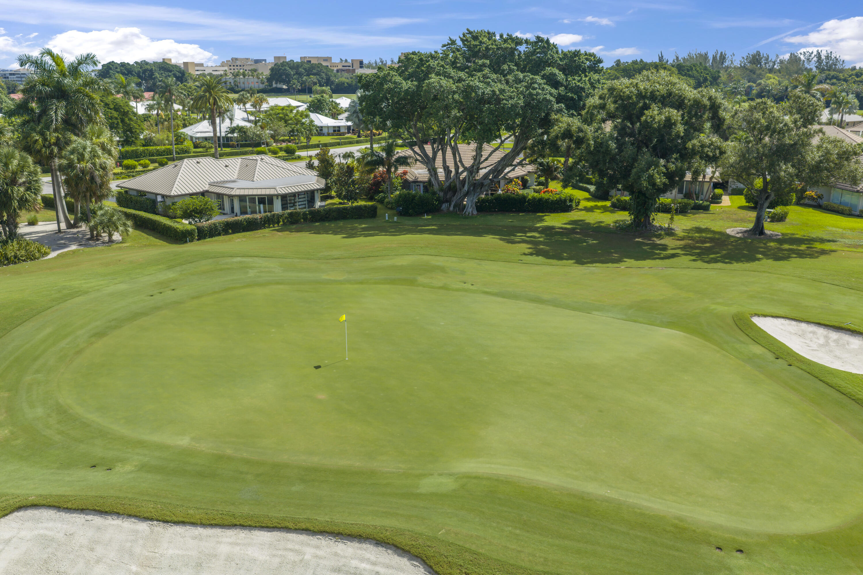 Golf course lot featuring expansive green fairways, sand bunkers, and mature specimen trees